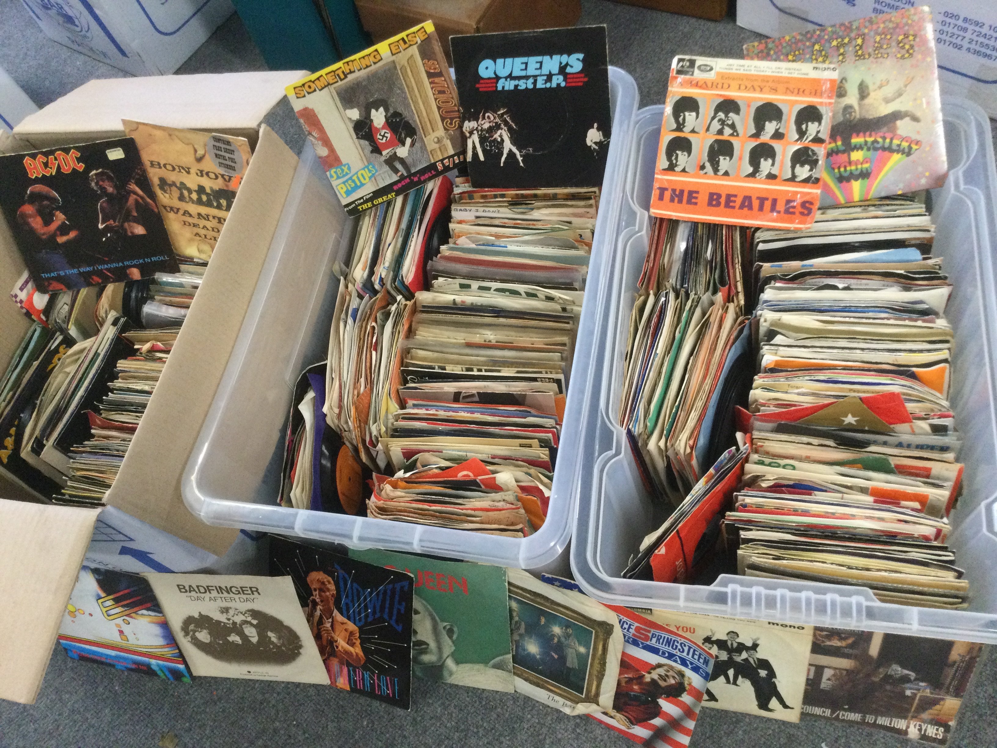Three boxes. Of 7" singles and EPs by various artists including David Bowie The Beatles, Sex Pistols, AC/DC and many more.