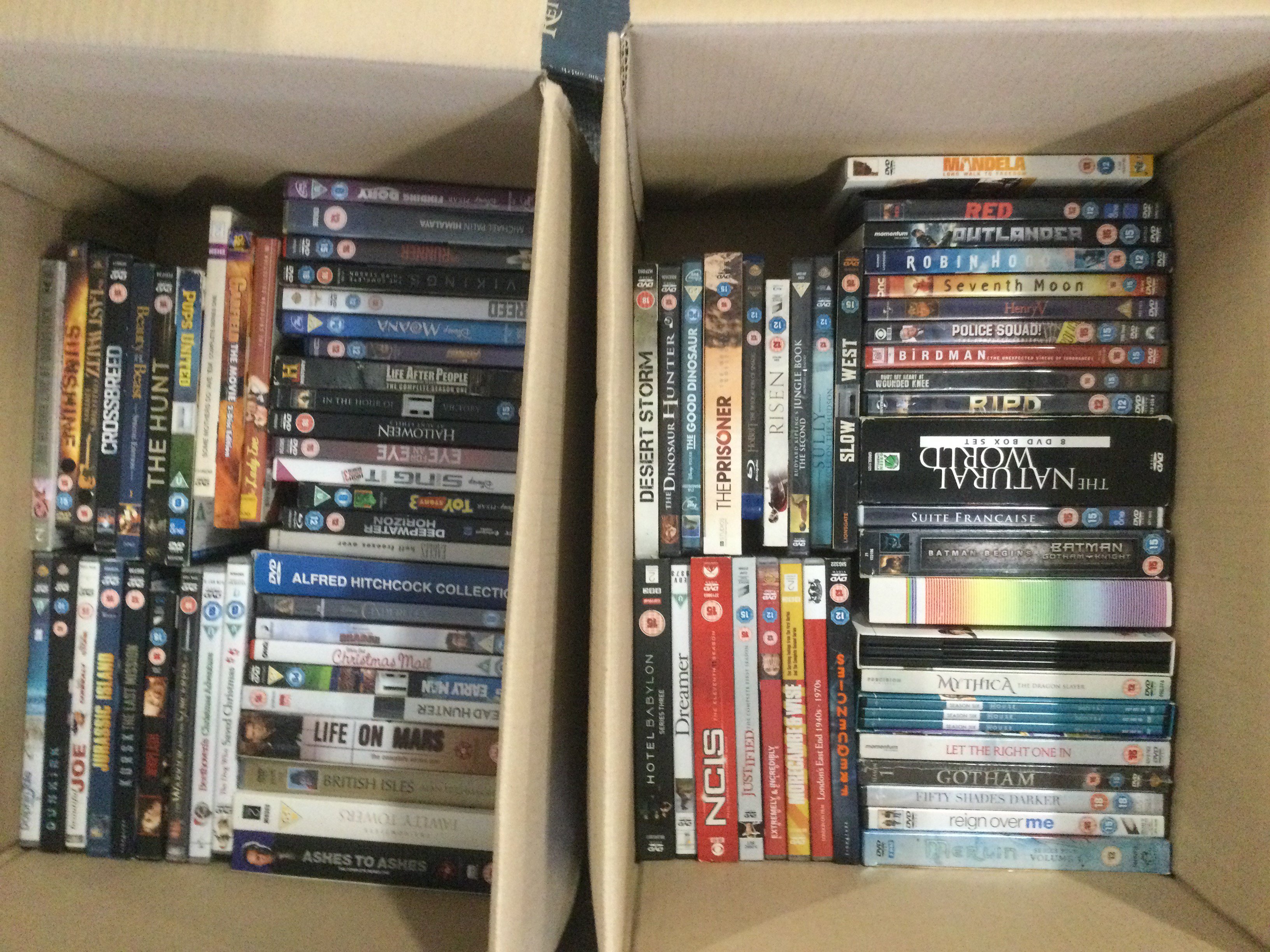 Four boxes of DVDs, BluRays and CDs.