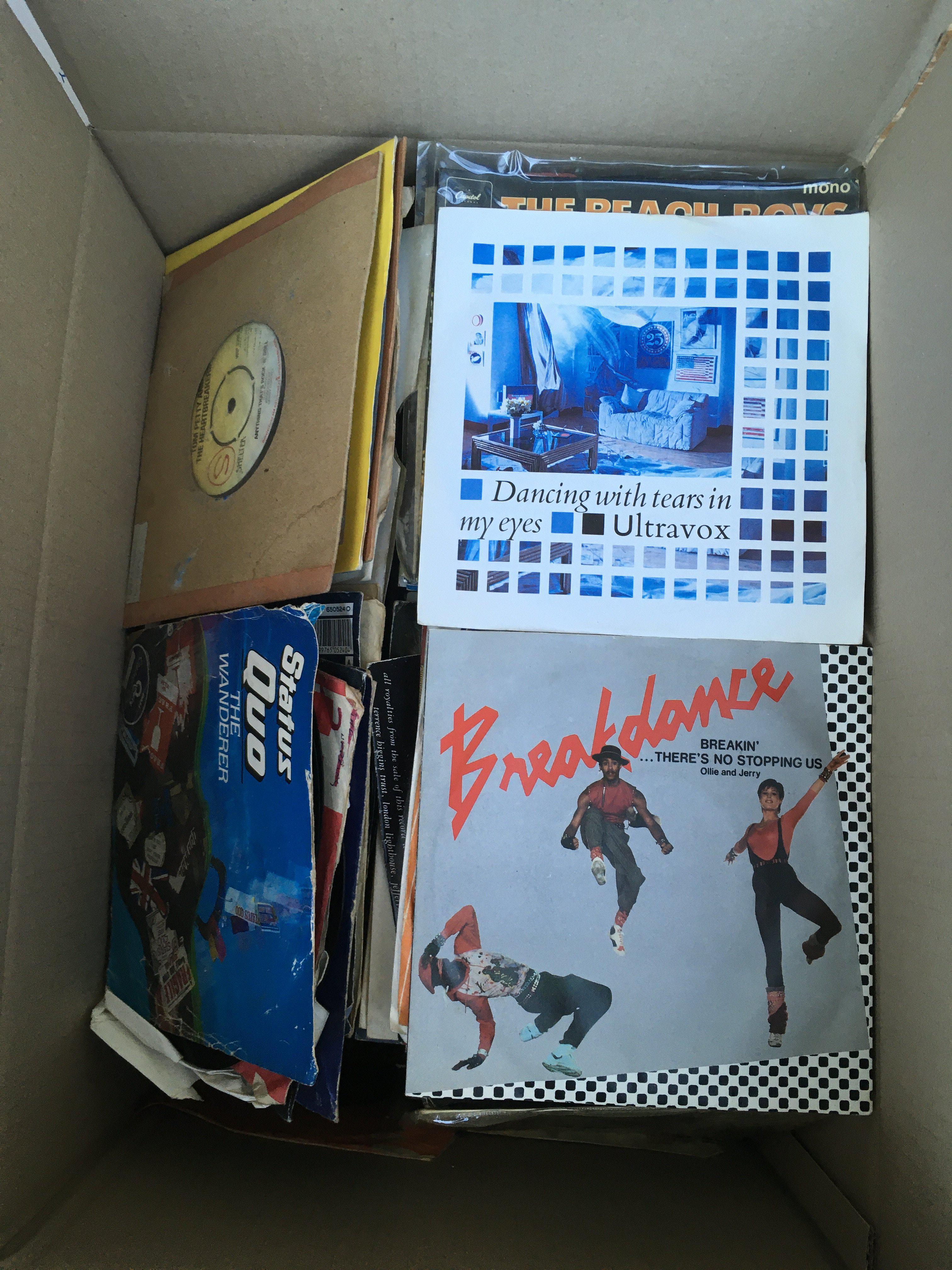 A box of 7" singles and EPs by various artists including The Beatles, Depeche Mode, The Undertones, Aztec Camera and many more.