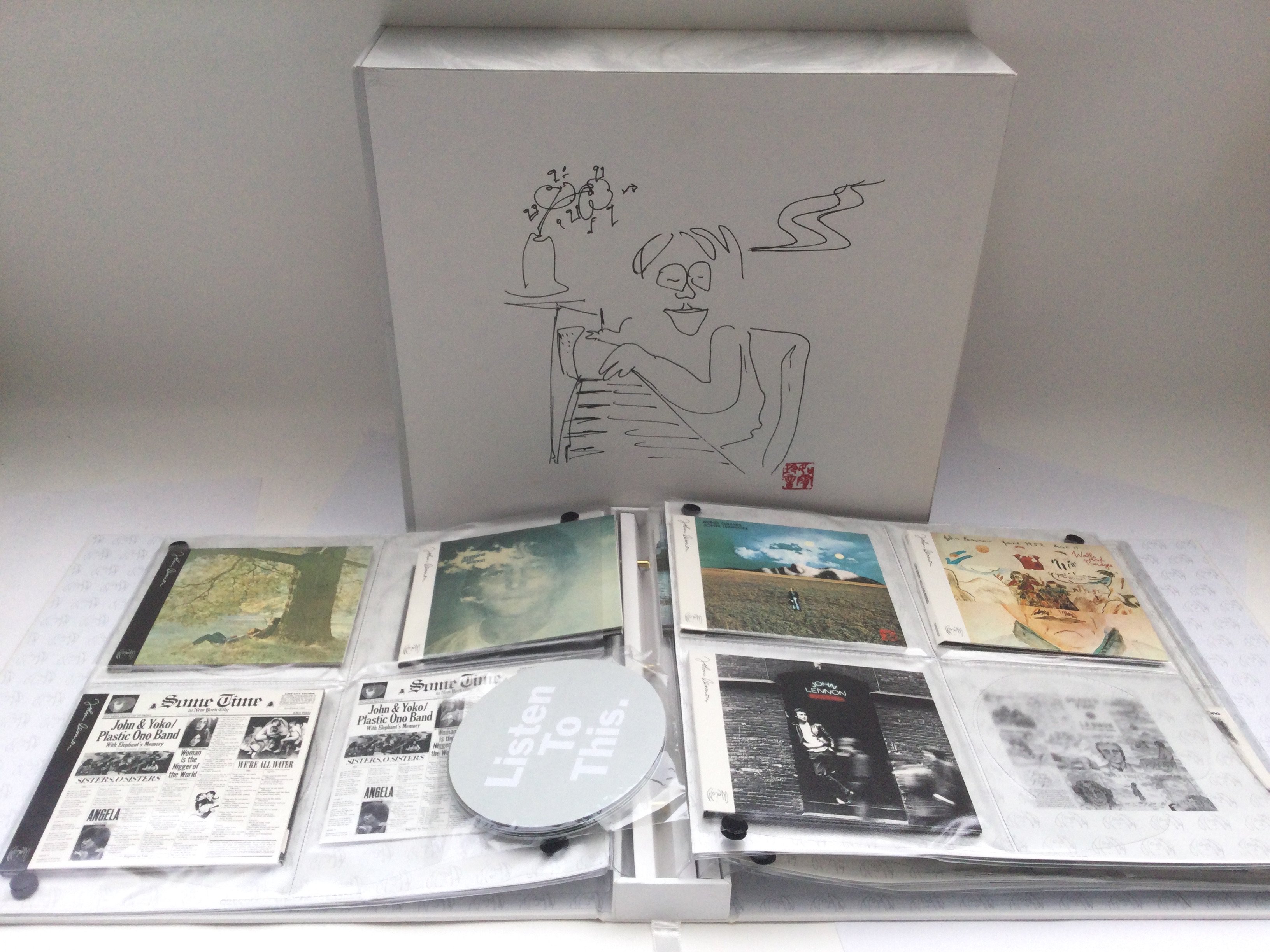 A John Lennon 'Box Of Vision' CD storage, catalogue and book plus contents.