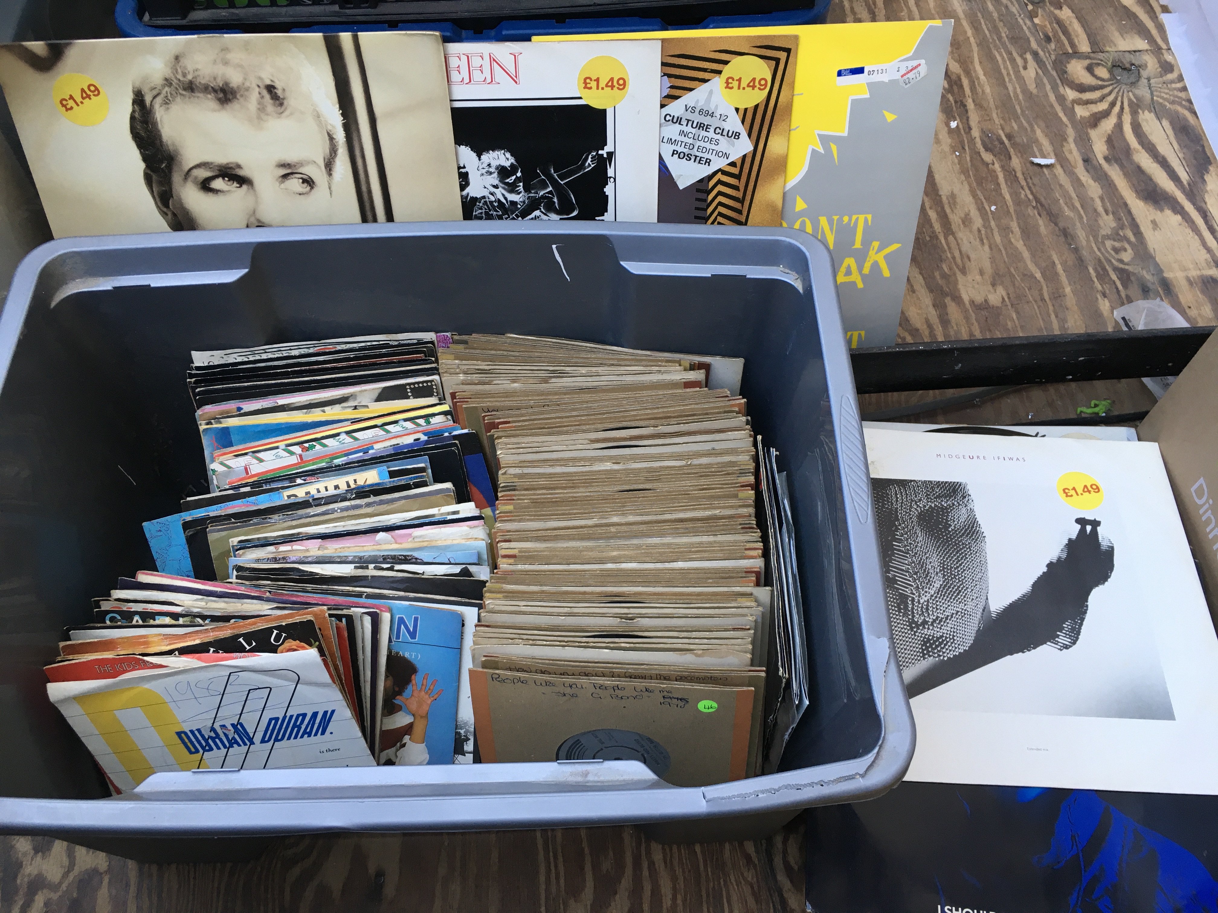 Two boxes of 12" and 7" singles by various artists including Queen, Elton John, John Lennon and others.