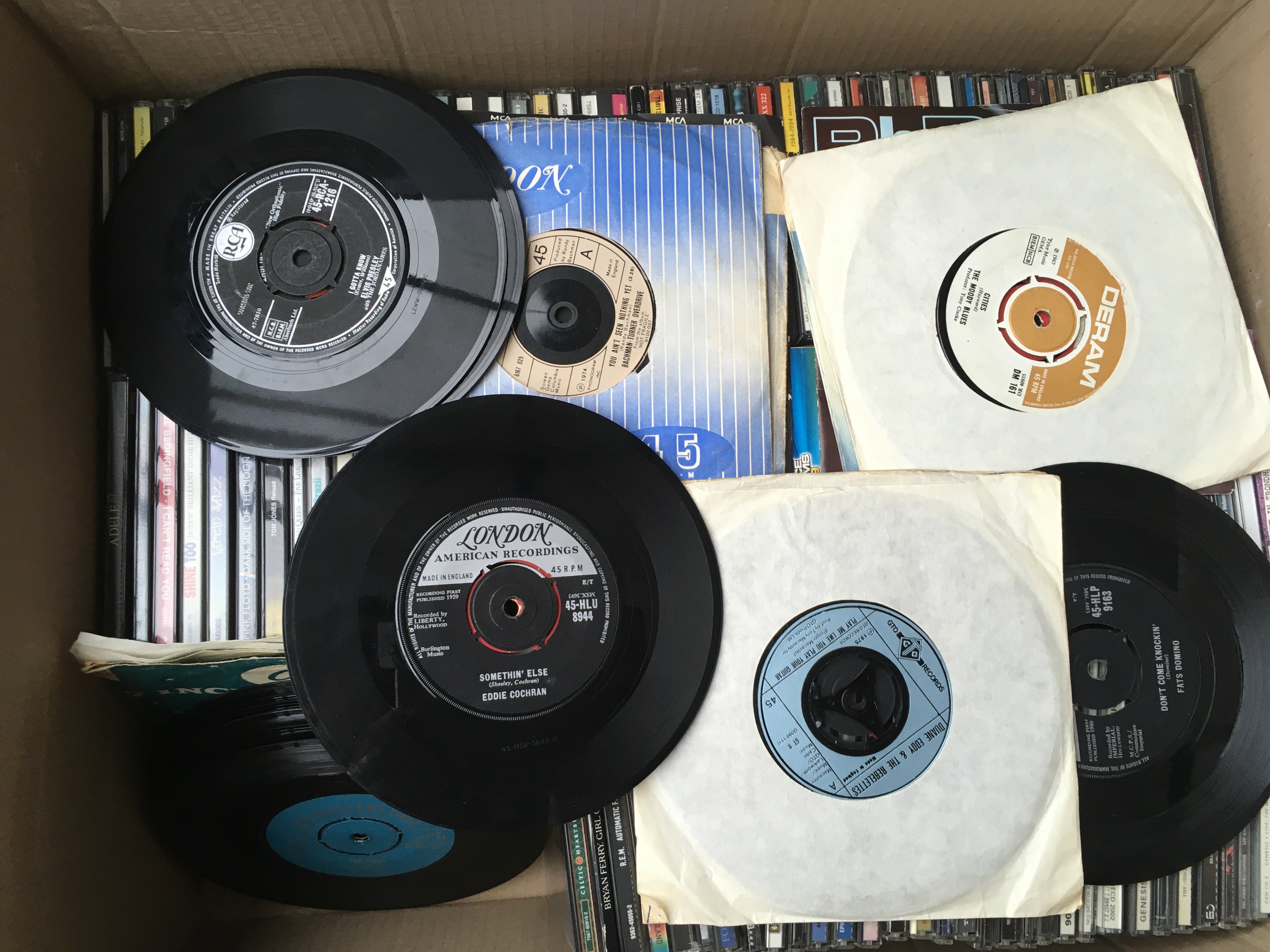 A box of CDs and 7" singles and two boxes of audio cassettes by various artists (3).