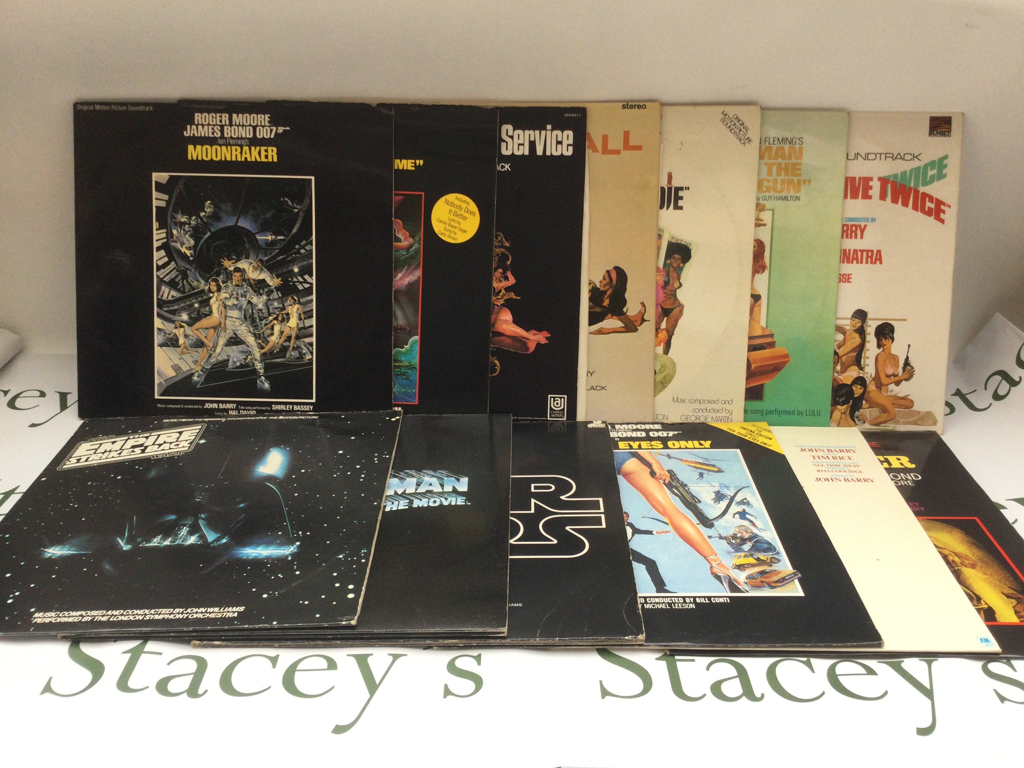 Thirteen James Bond movie soundtrack LPs.