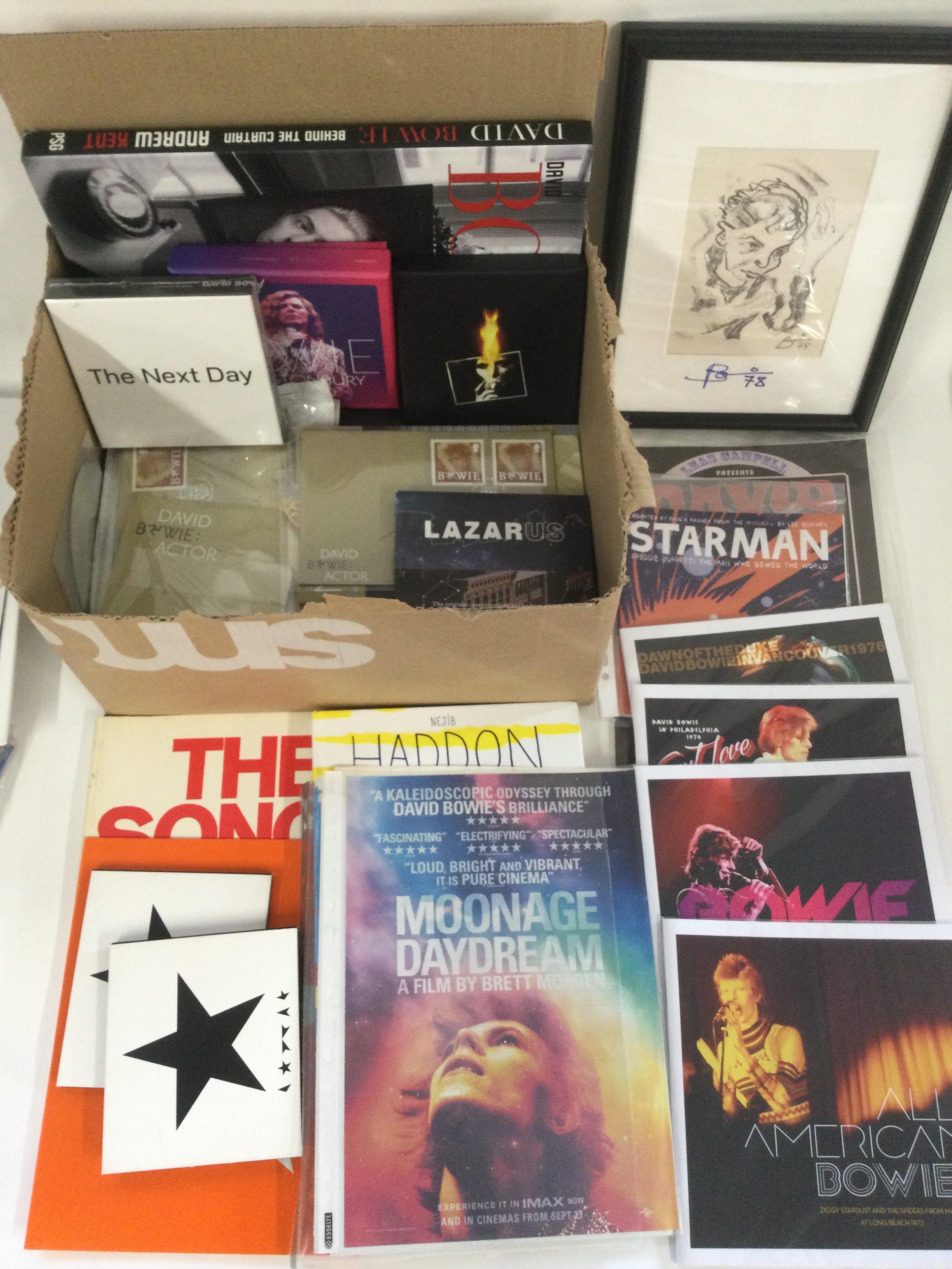 A collection of David Bowie ephemera comprising photographs, books, CDs, trading cards, stamps etc.