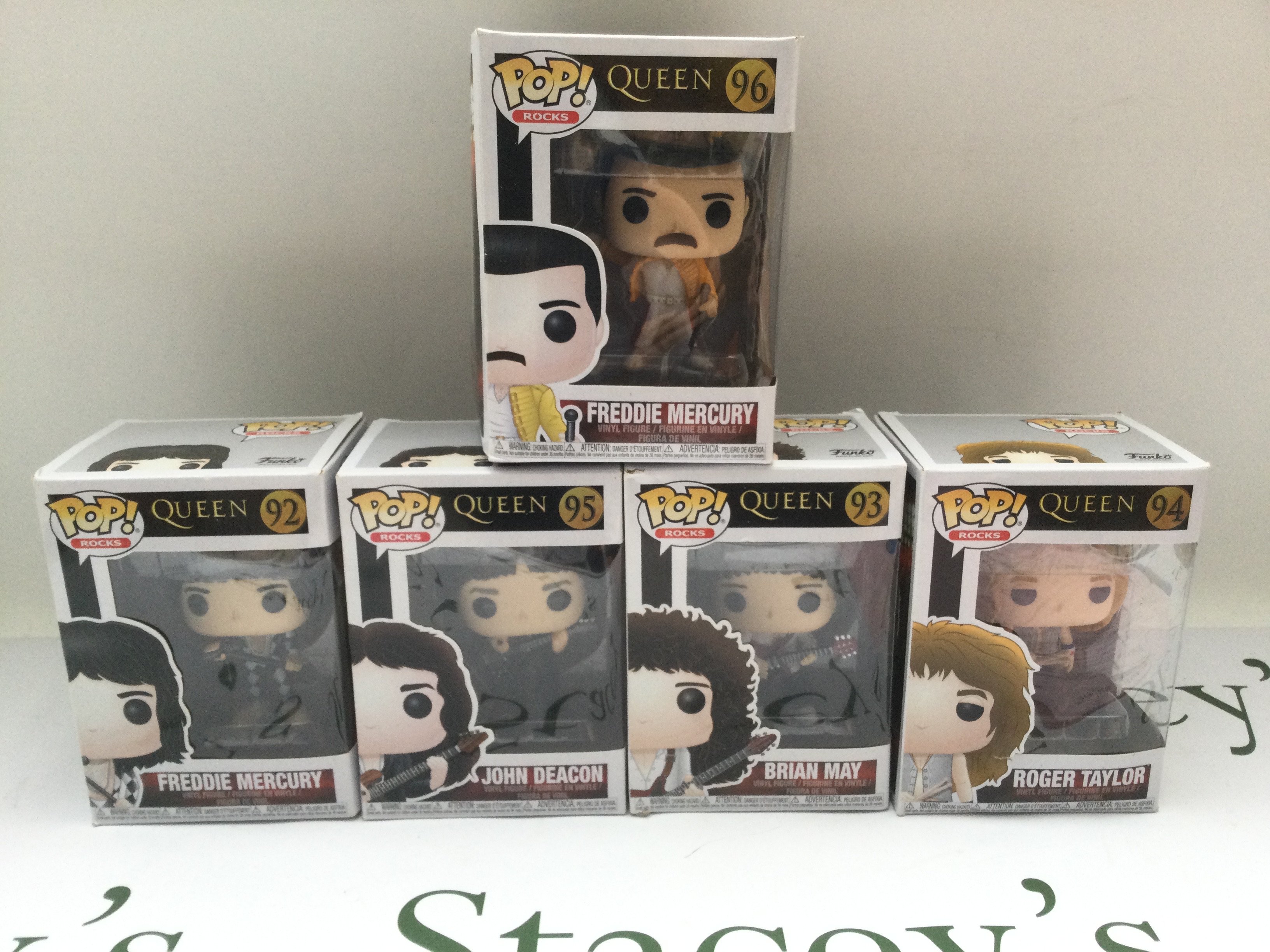 Five boxed Queen Funko Pop figures.