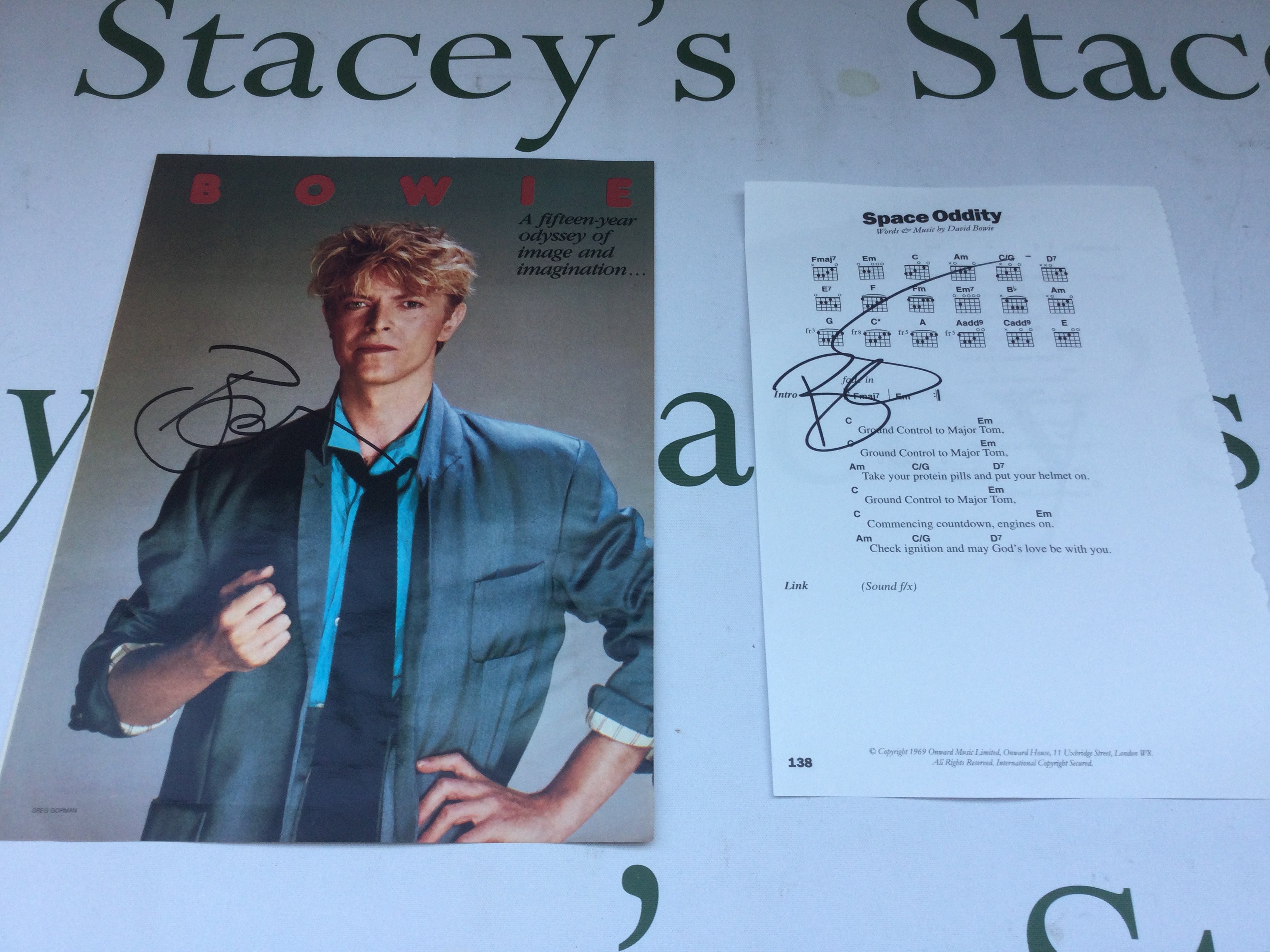 A David Bowie signed page of Space Oddity guitar tablature and lyrics plus a signed magazine page (2).