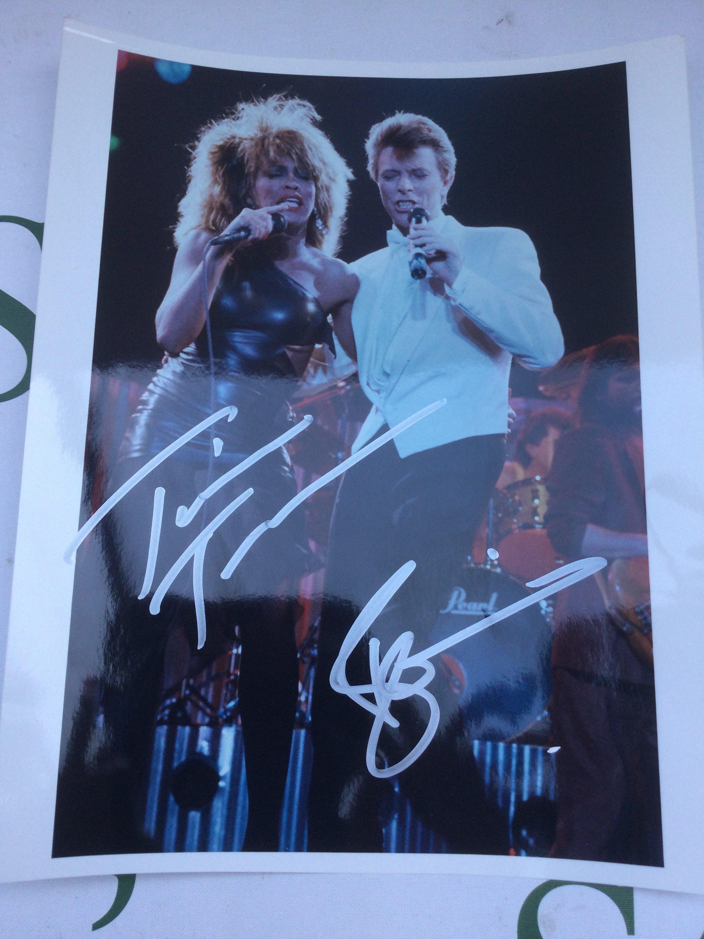 A signed photo of David Bowie and Tina Turner, approx 20cm x 26.5cm.
