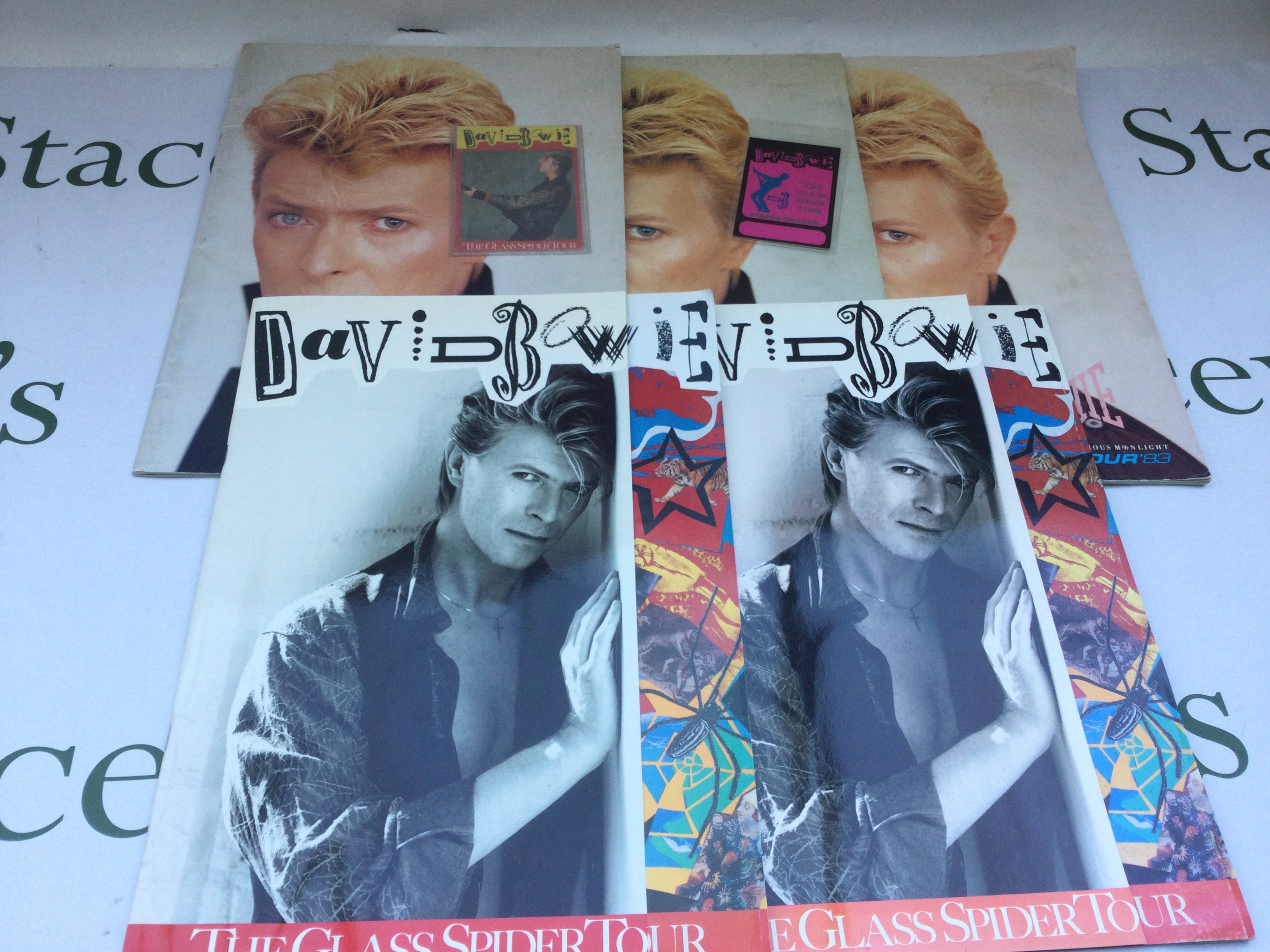 Five David Bowie tour programmes comprising three for the Serious Moonlight tour and two for the Glass Spider tour with accompanying tour laminate and ticket.