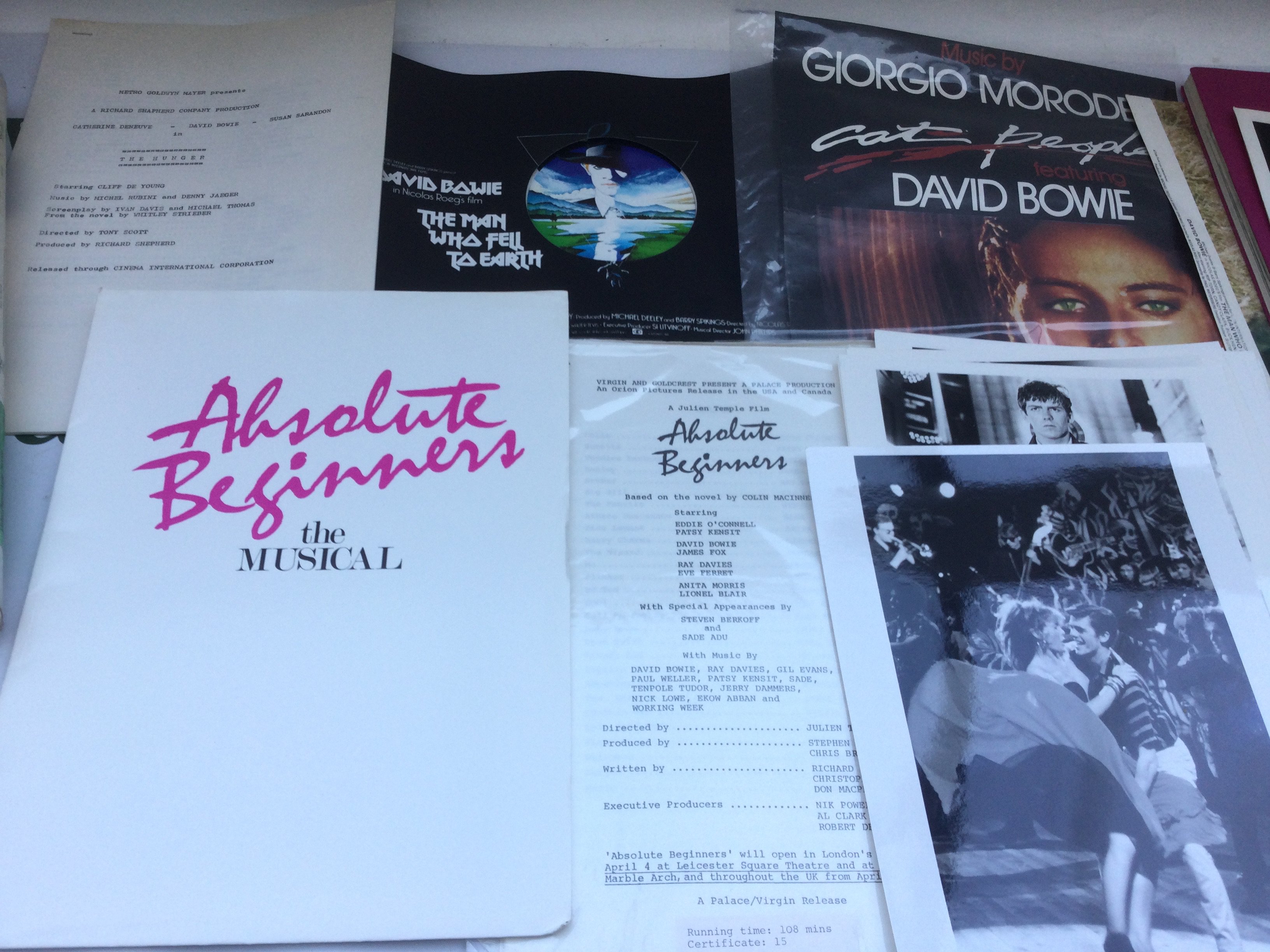 A collection of David Bowie movie ephemera comprising 'The Man Who Fell To Earth' promotional items, a signed promotional picture, 'The Hunger' script, 'Absolute Beginners' script and film stills.
