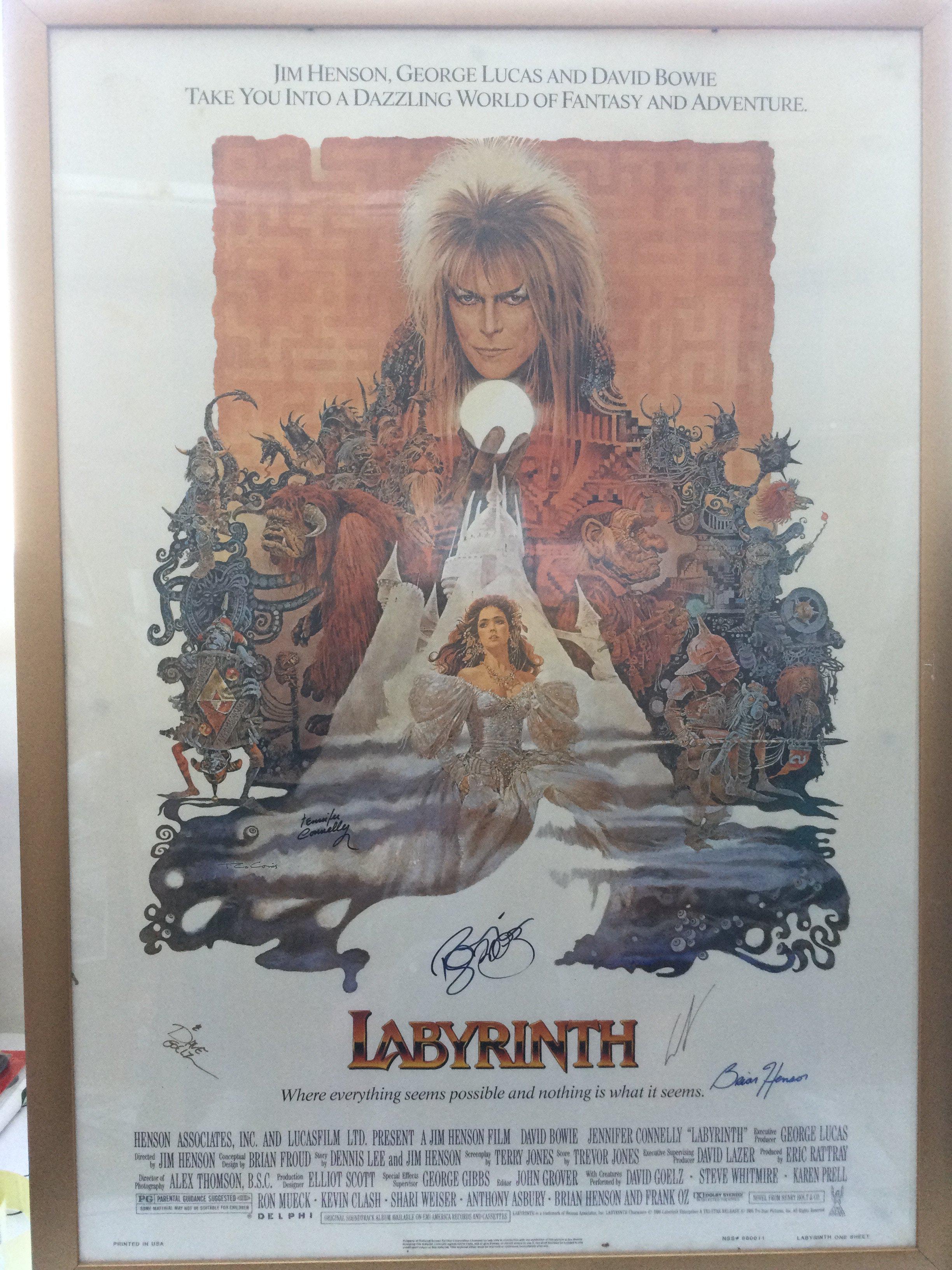 A multi signed US one sheet film poster of Labyrinth bearing the signatures of David Bowie, George Lucas, Frank Oz, Brian Henson, Jennifer Connelly and David Goelz. Framed and glazed, no folds or obvious damage.