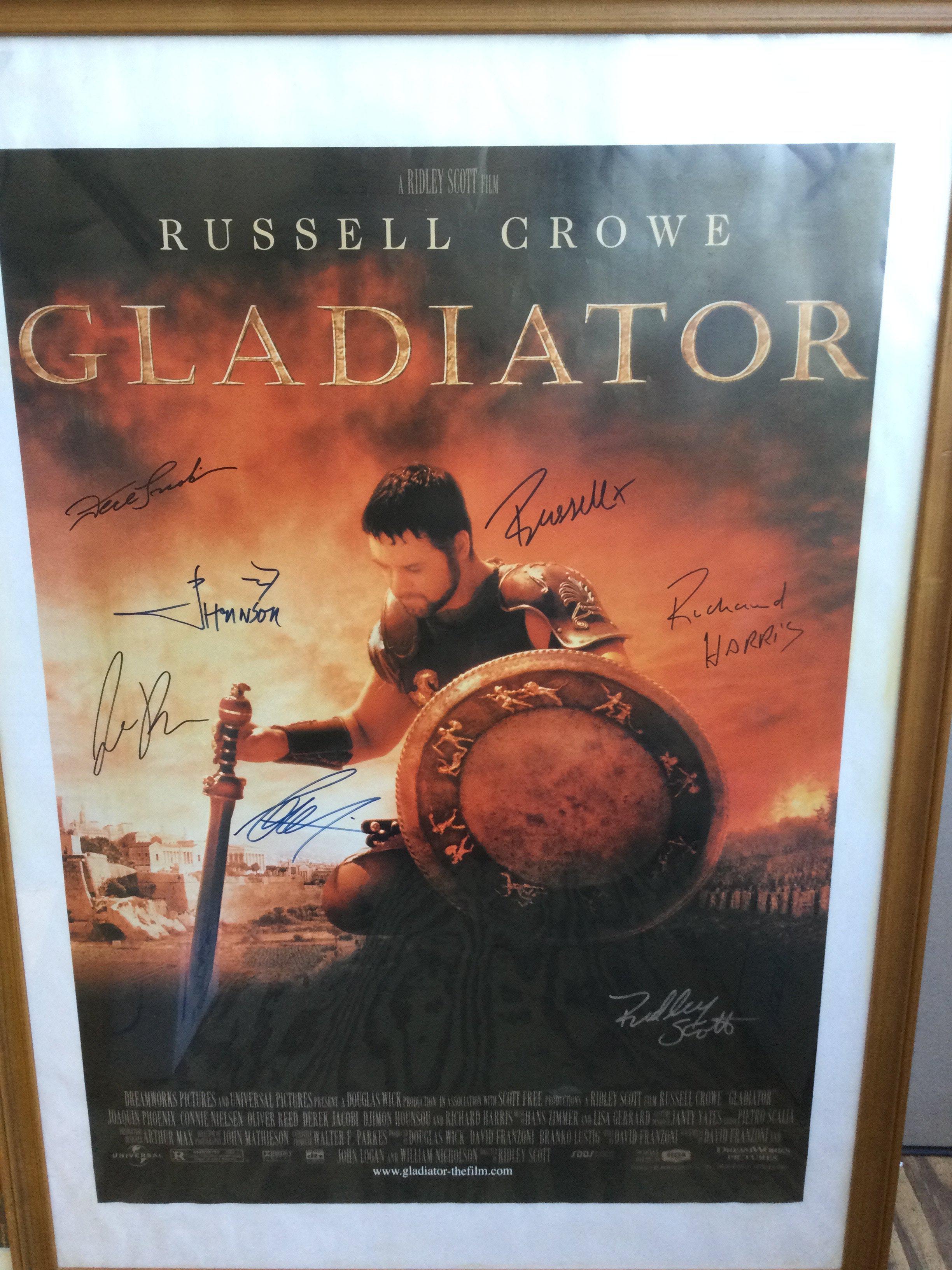 A multi signed Gladiator film poster signed by Russell Crowe, Ridley Scott, Richard Harris, Derek Jacobi and others, framed and glazed, no folds.