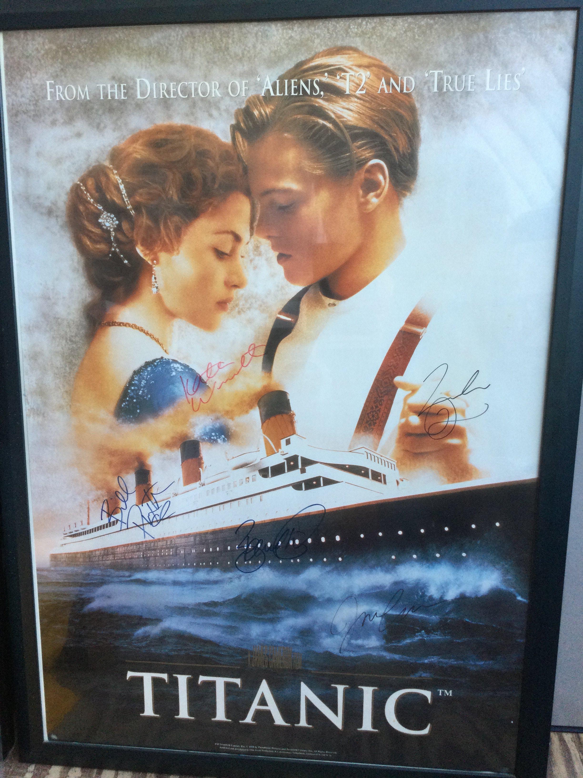 A multi signed US one sheet film poster for James Cameron's Titanic, signed by Leonardo DiCaprio, Kate Winslett, James Cameron, Bill Paxton and Bernard Hill. Framed and glazed, not folded.