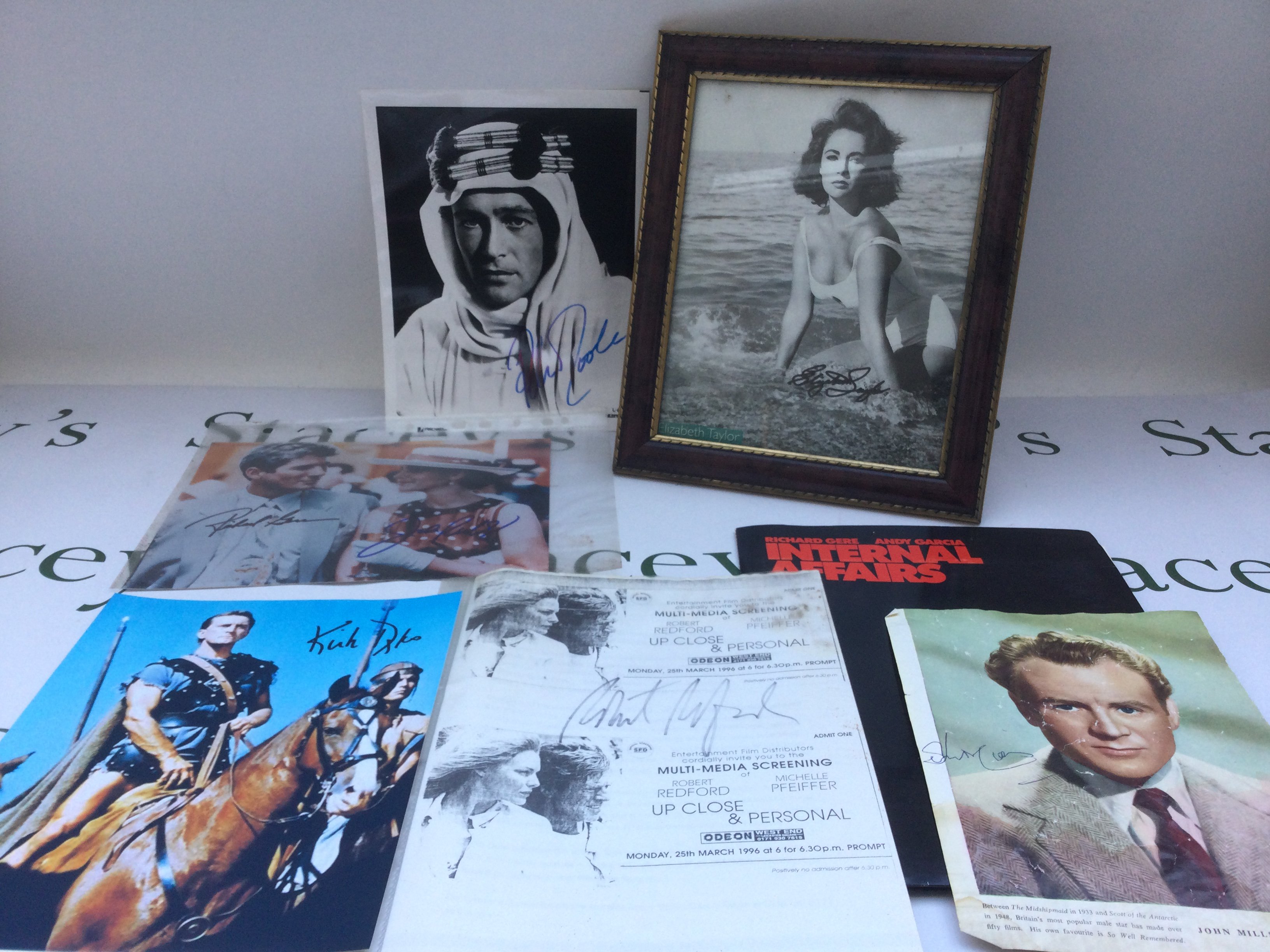 A collection of movie star autographs comprising Sir John Mills, Kirk Douglas, Peter O'Tools, Elizabeth Taylor and others plus an 'Internal Affairs' press pack.