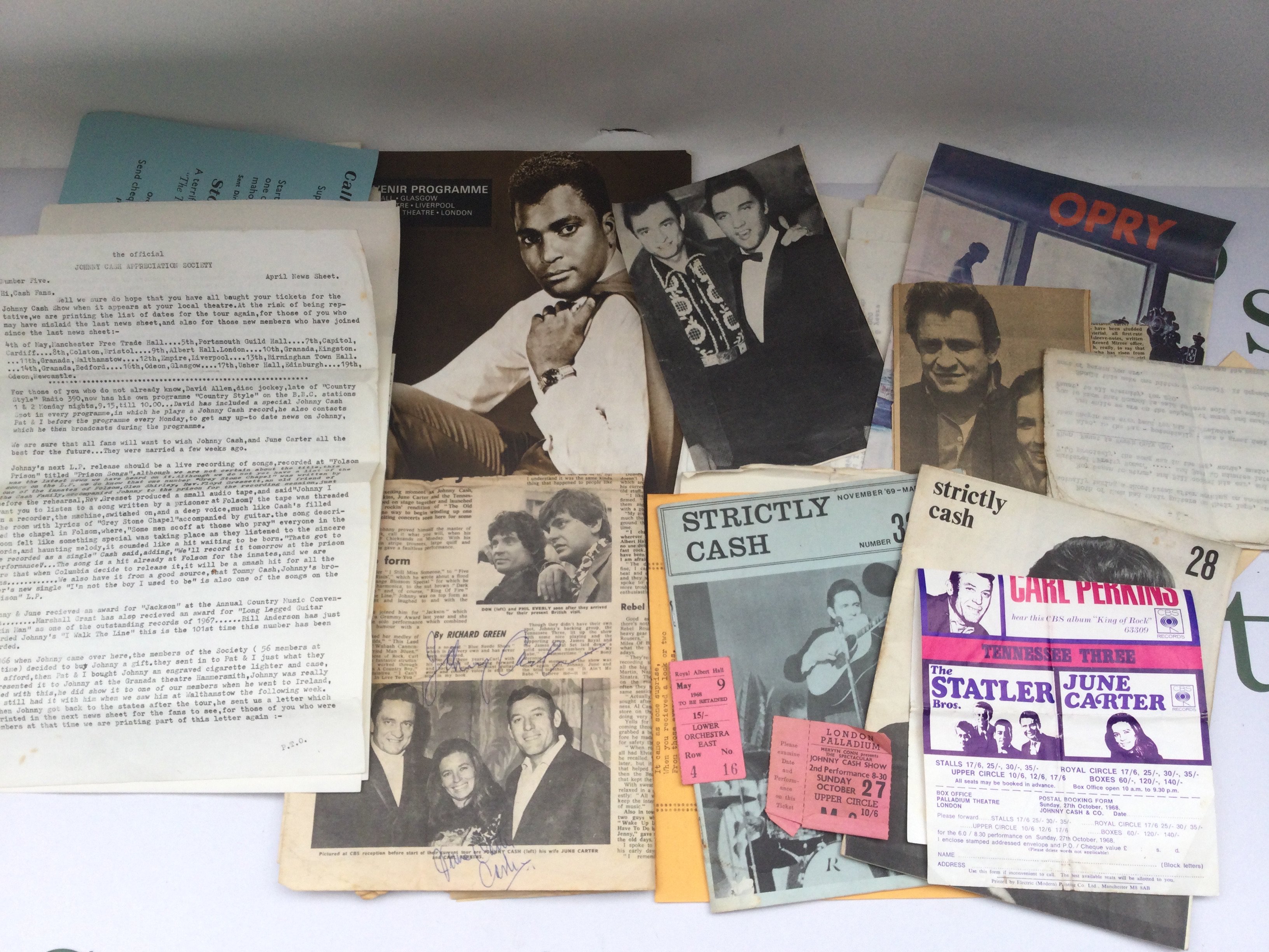 A newspaper page signed by Johnny Cash and his wife June Carter Cash plus a collection of mainly Johnny Cash memorabilia including two show tickets, fanzines etc.