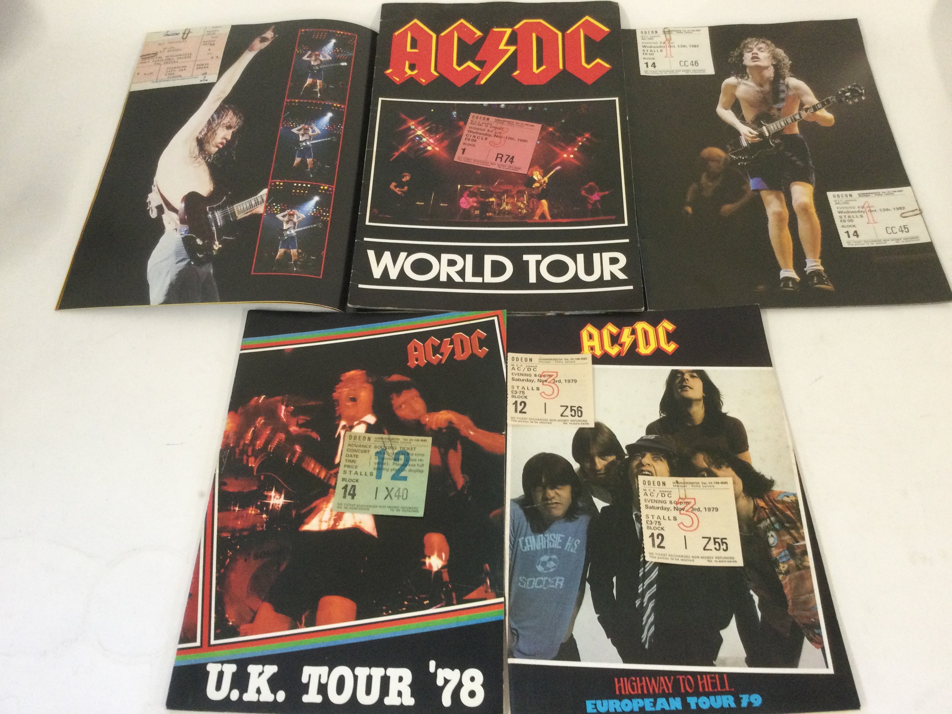 Five AC/DC concert programs and tickets, various dates.