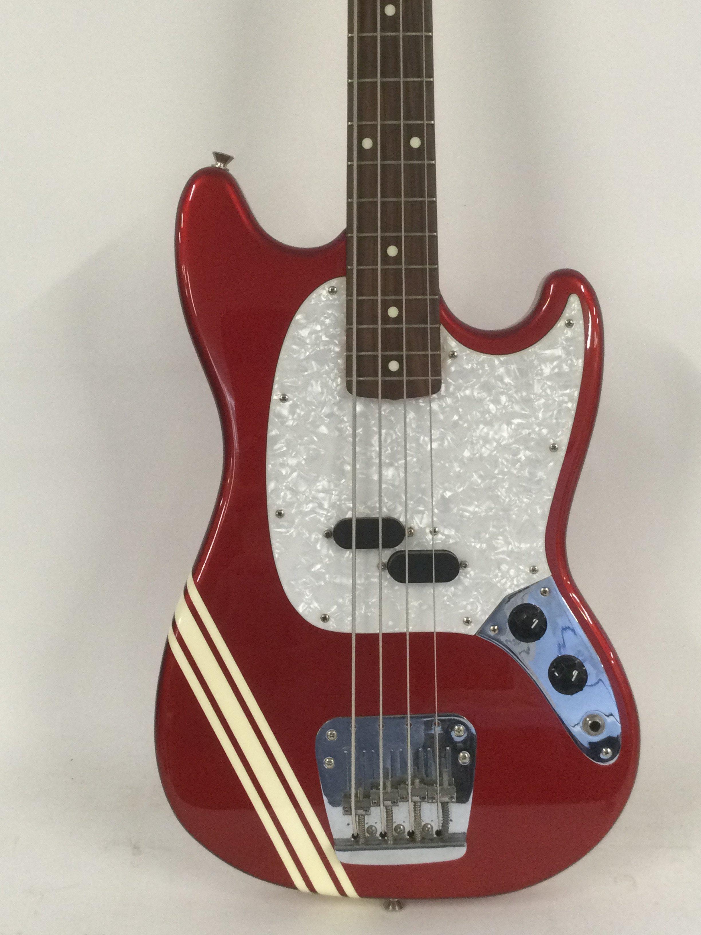 A Fender Mustang Bass guitar in a dakota red competition finish, made in Japan.