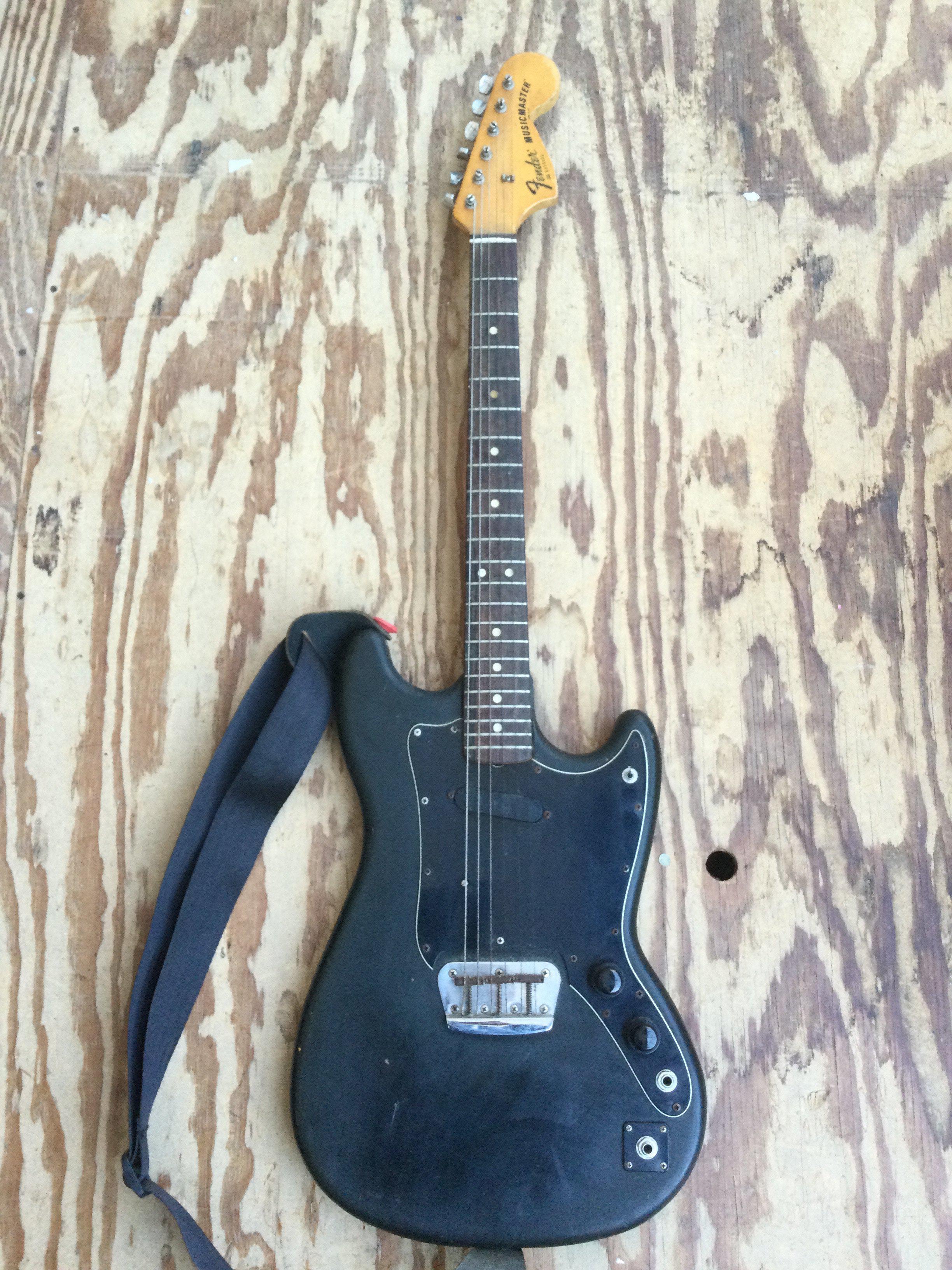 A 1978 Fender Musicmaster electric guitar modified with two jack plates and replacement tone and volume pots plus further modifications. Comes with a Fender branded soft carry case.