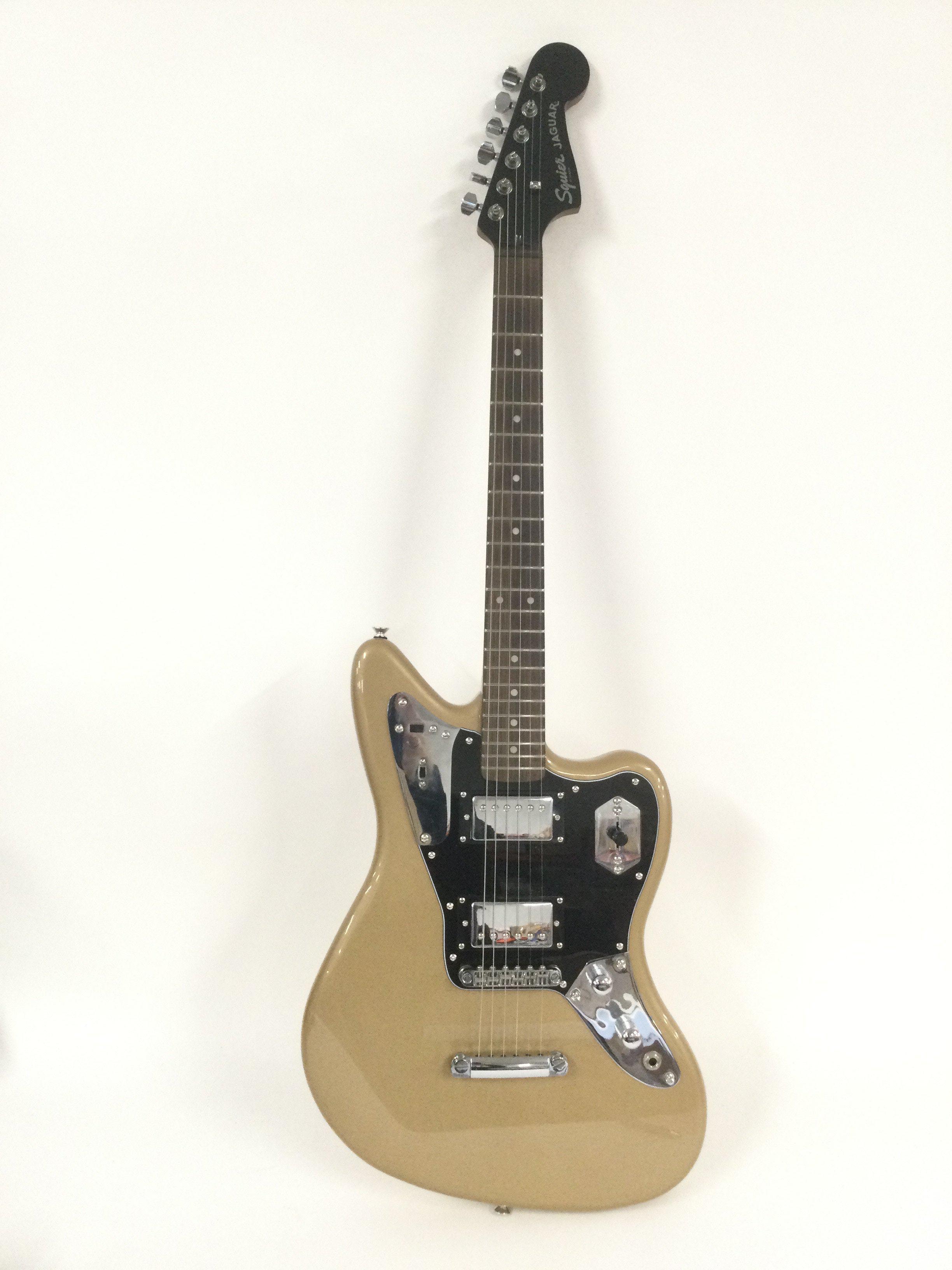 A 2014 Fender Squier Jaguar electric guitar in a gold sparkle finish. Comes with retail box.