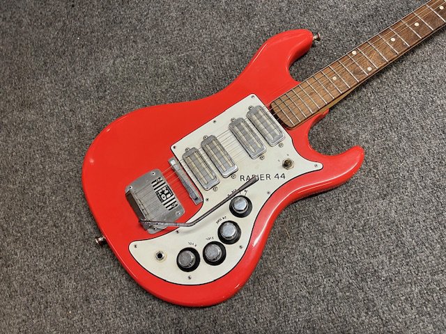 An all original 1963 Watkins Rapier 44 electric guitar. This was the top of the line in the Rapier models, the 44 having 4 foil toaster type pickups. This is in all original condition with larger 1962 to1963 Hi Lo Badge on the HiLo fulcrum blade vibrato. Arm still in place. Original pickups, parts, controls bright work. Teardrop backed Van Gent Tuners and triangular gold Watkins Treble Clef decal on the headstock. All original finish with nice patina but no evidence of heavy playwear. Some edge wear in the form of damage to the upper lower edge to lower body otherwise fine . A very nice early 1960s British Beat Boom era in very good + condition for its age. No Case