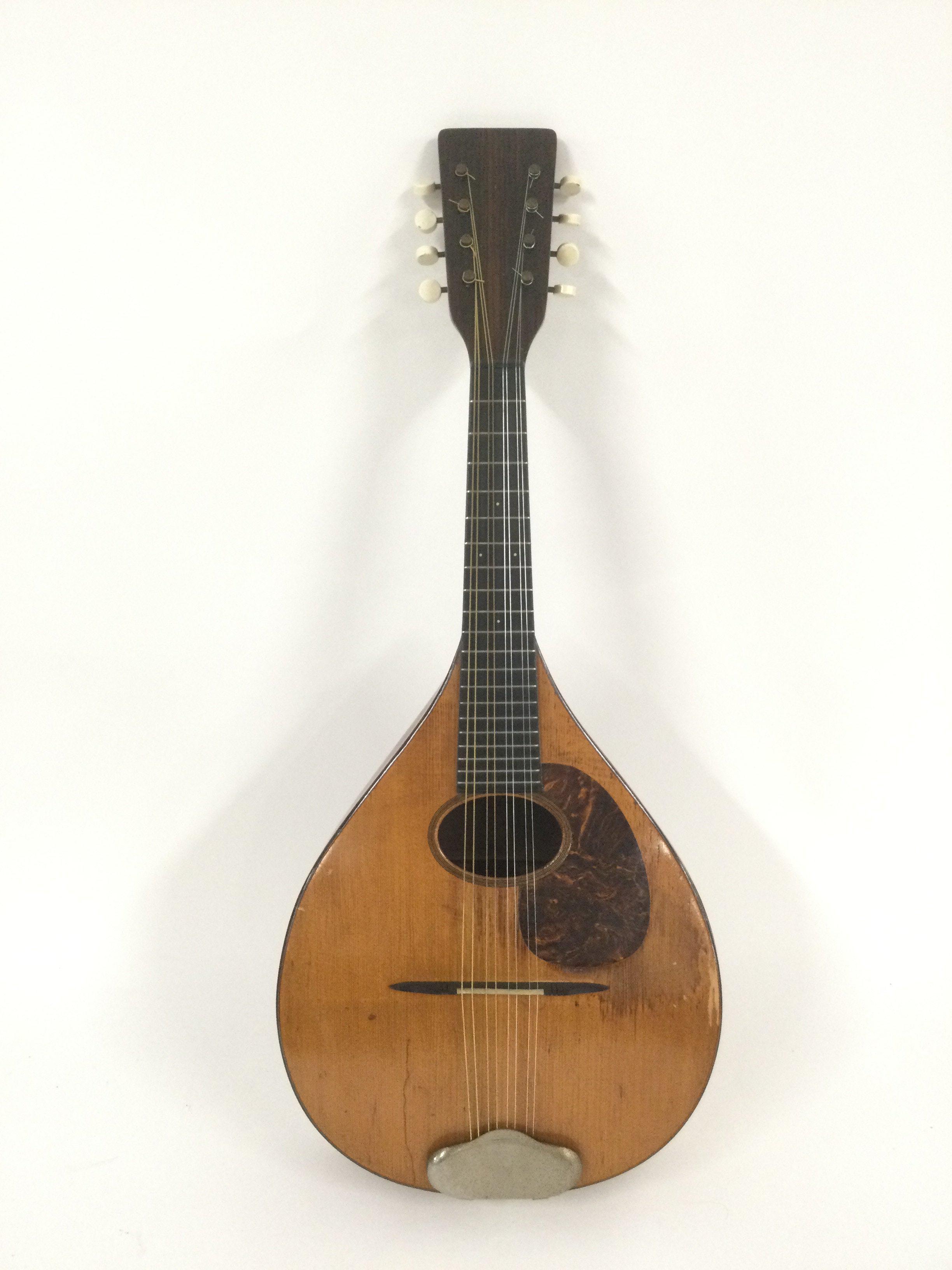 A 1923 CF Martin & Co mandolin. Comes supplied with original case and a new example.