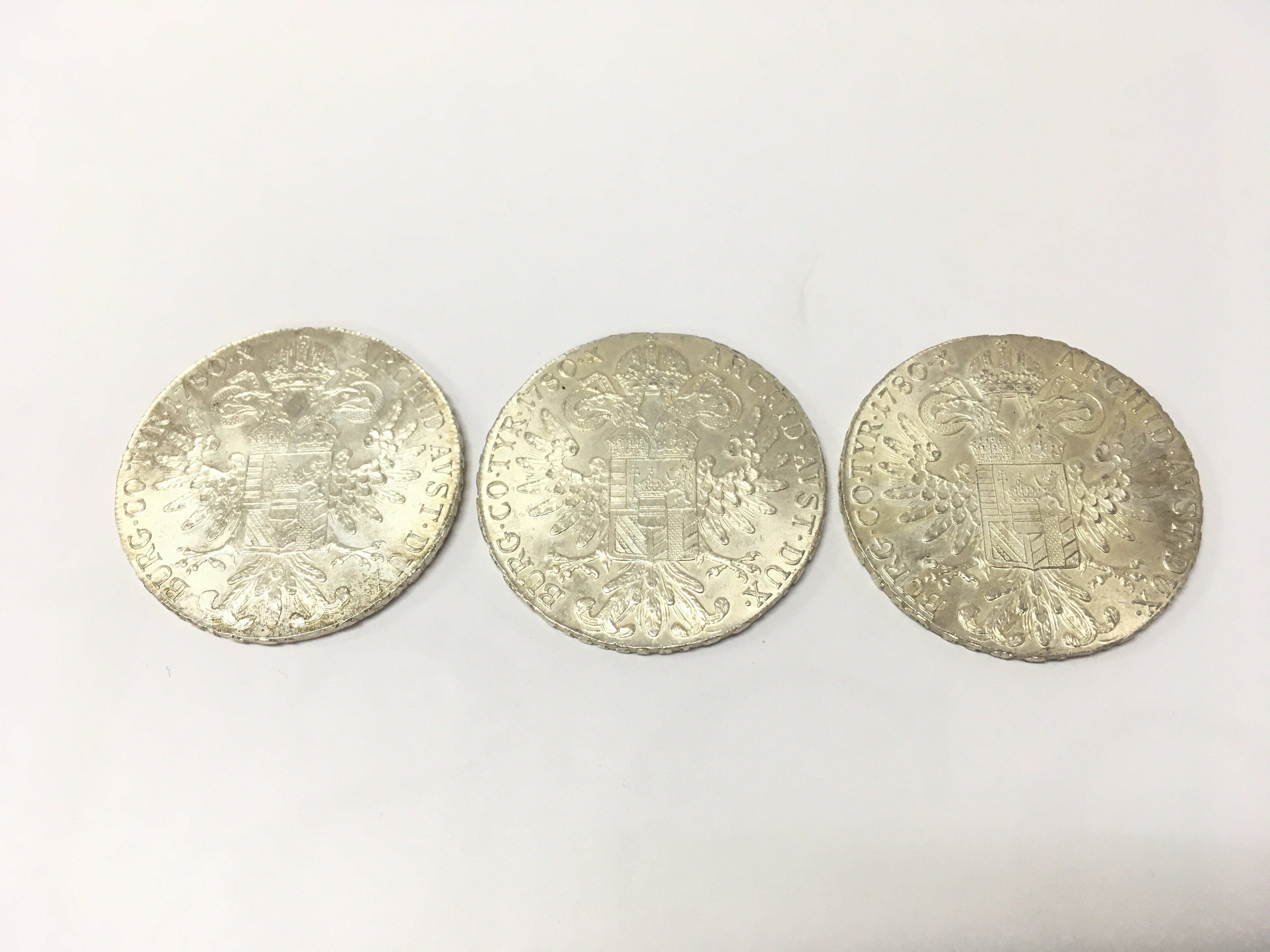 Three Austrian Maria Theresa Thaler silver coins , 84.4g total weight . Postage category A
