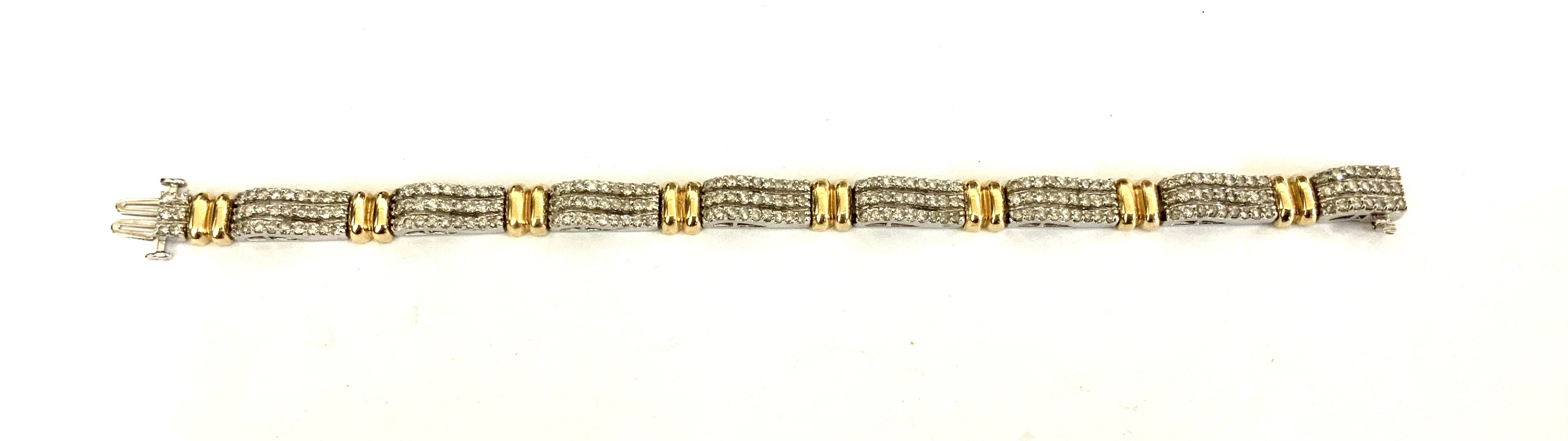A good quality 14ct yellow and white gold bracelet made up of 8 sections each inset with 27, 0.01ct stones (total weight approximately 2.16ct). (A)
