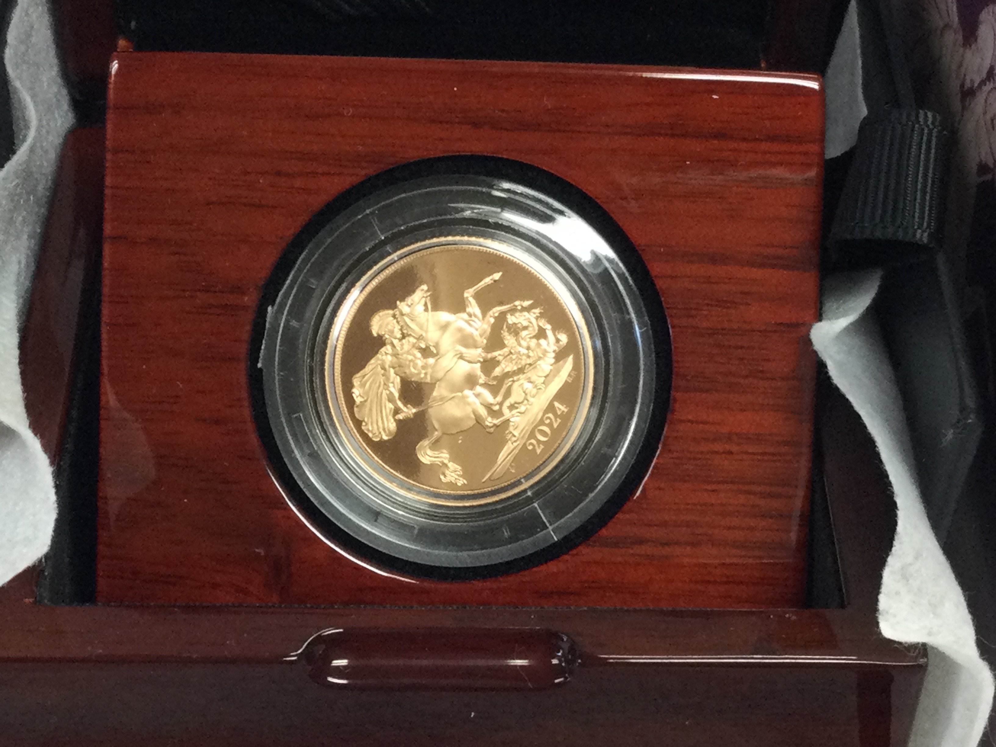 A 2024 gold proof sovereign. Postage B