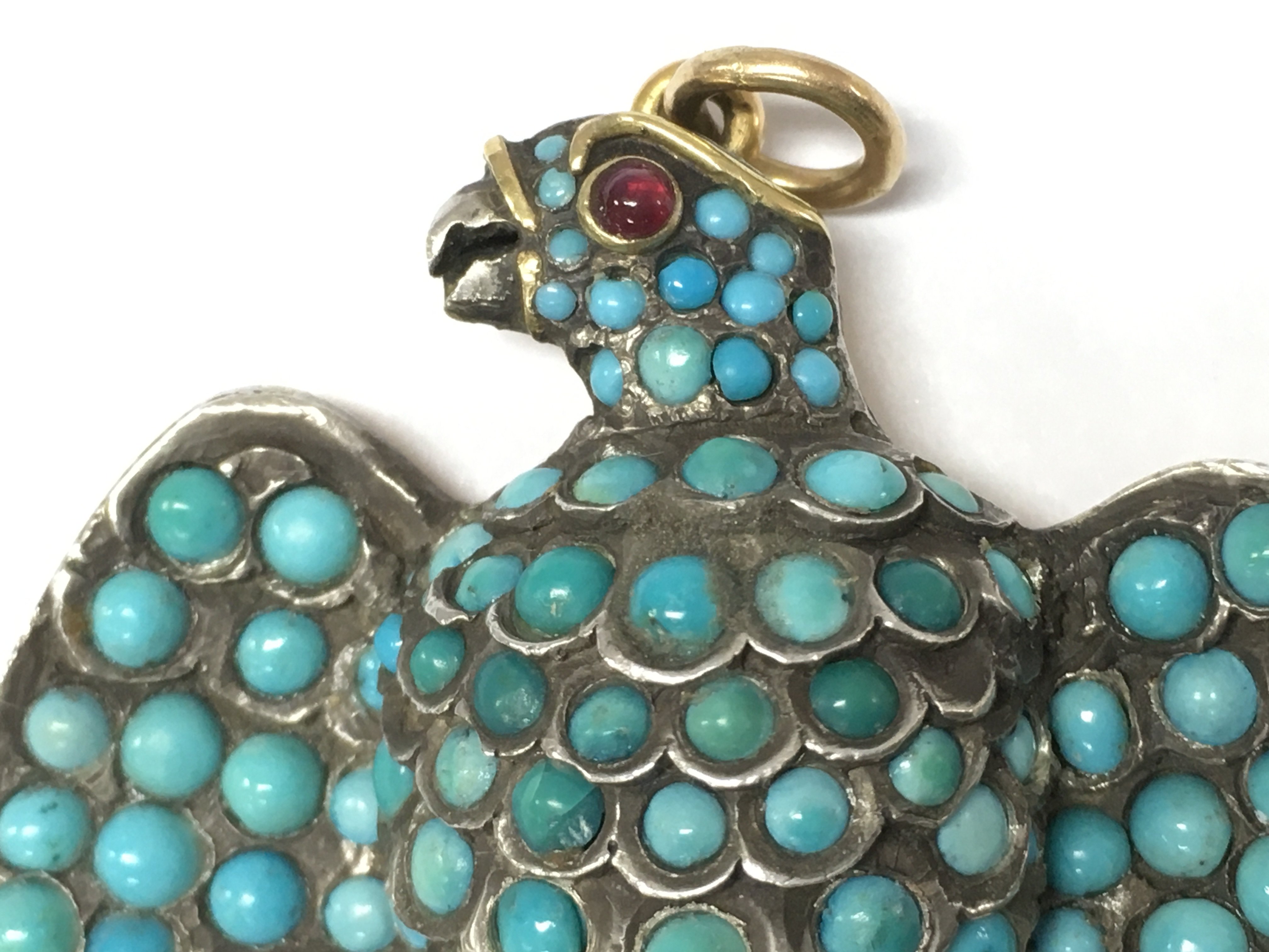 withdrawn - An early Victorian gold silver eagle turquoise mourning pendant with locket and ruby set eye , 4cm wide. Postage category A
