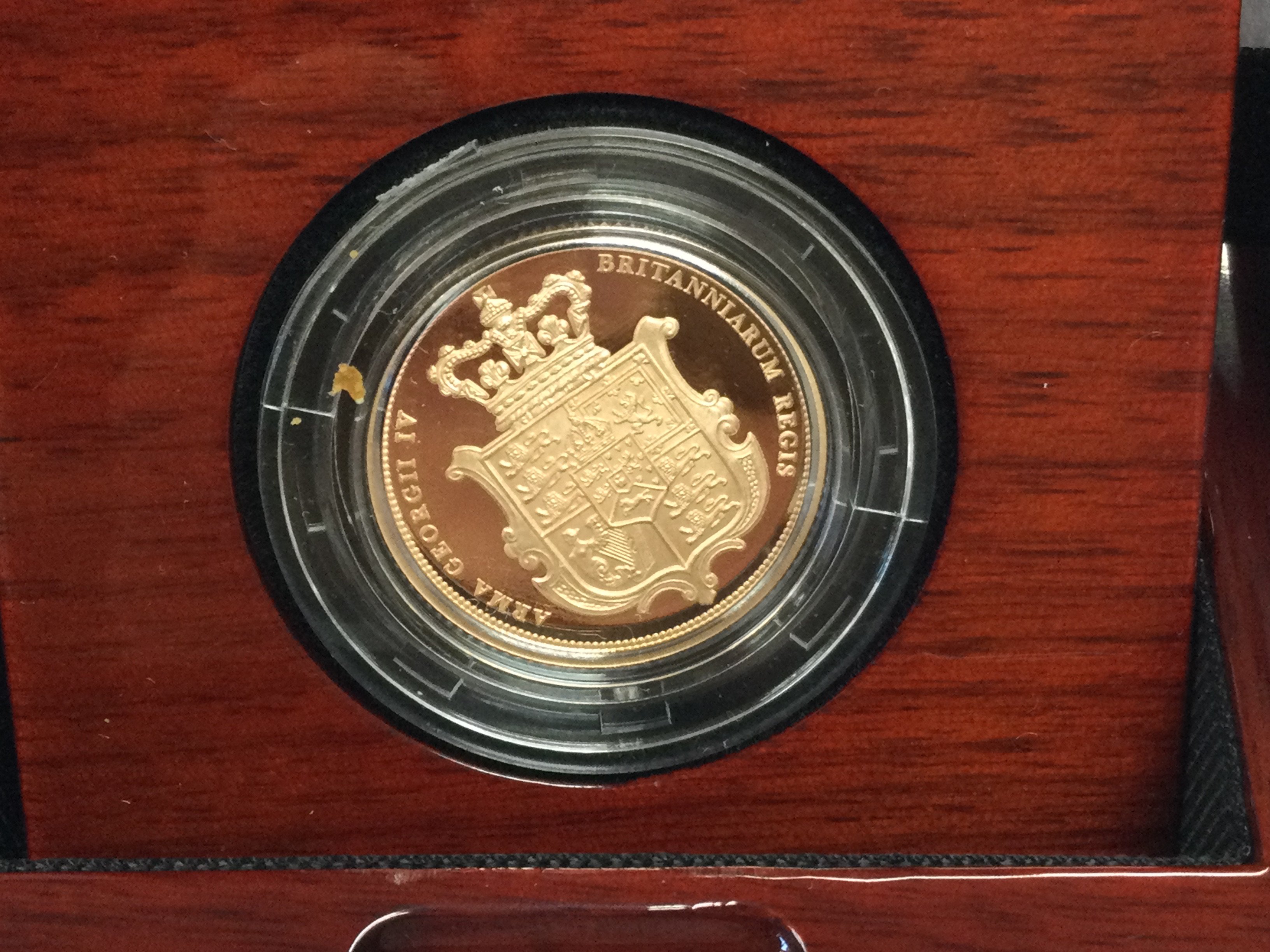 A 2025 gold proof sovereign. Postage B
