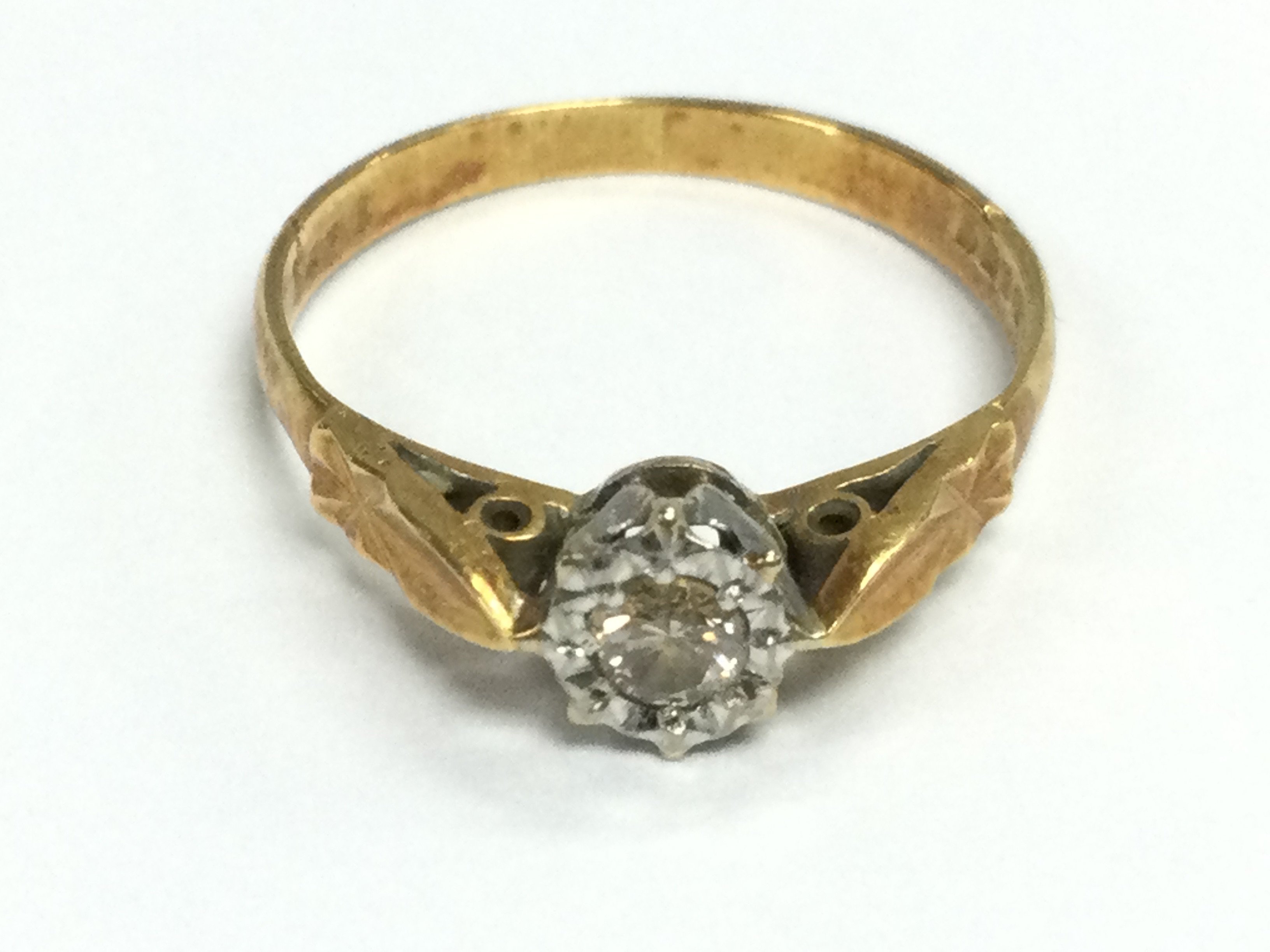 An 18ct gold solitaire diamond ring. Size N and approximately 2.10g Postage A