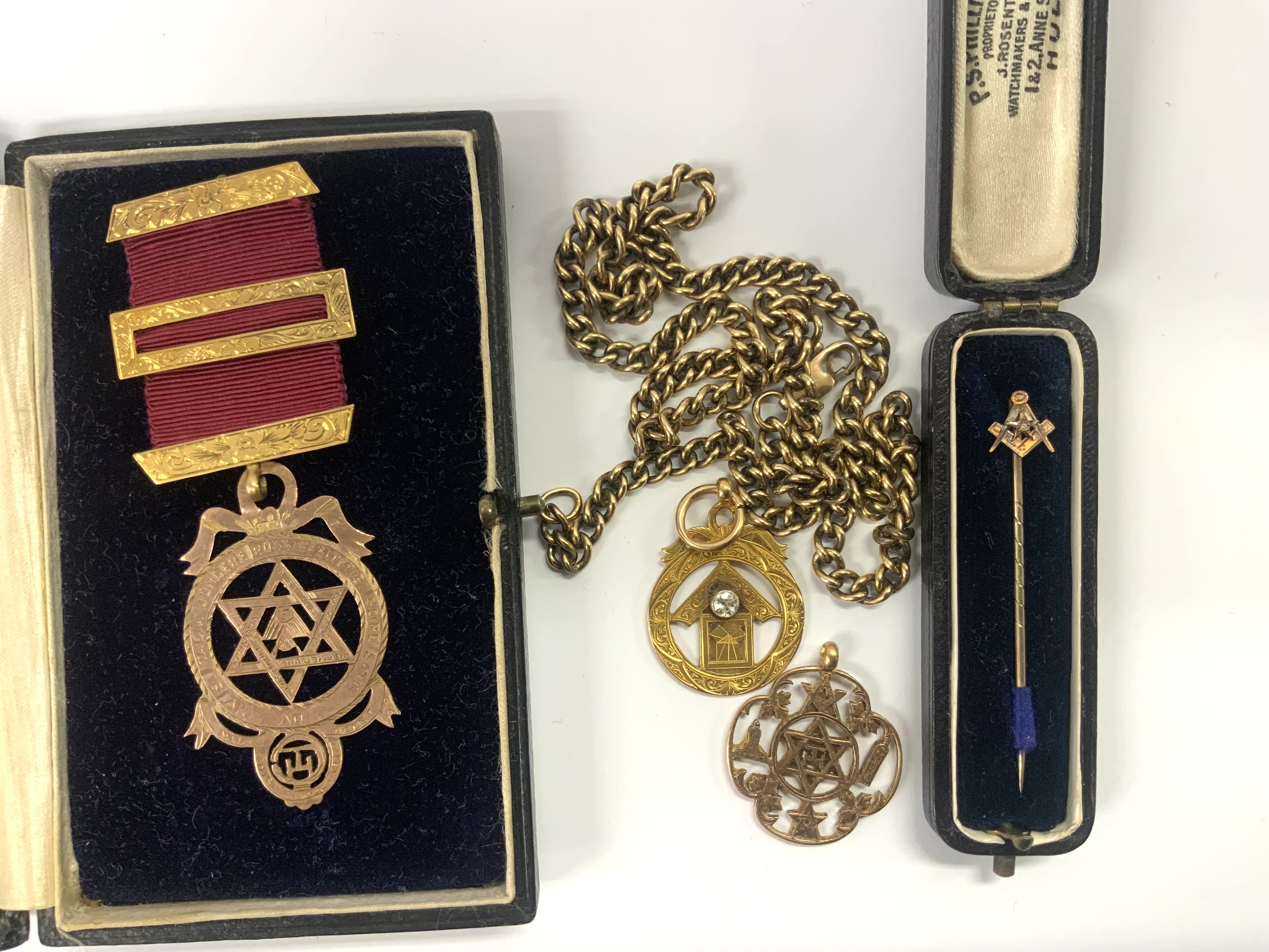Mixed lot to include. A 9ct gold Masonic Jewel, 9ct gold chain, 26.1g, 2 15ct gold Masonic design fobs. 9.4g, 9ct gold Masiconic design stick pin. (a)