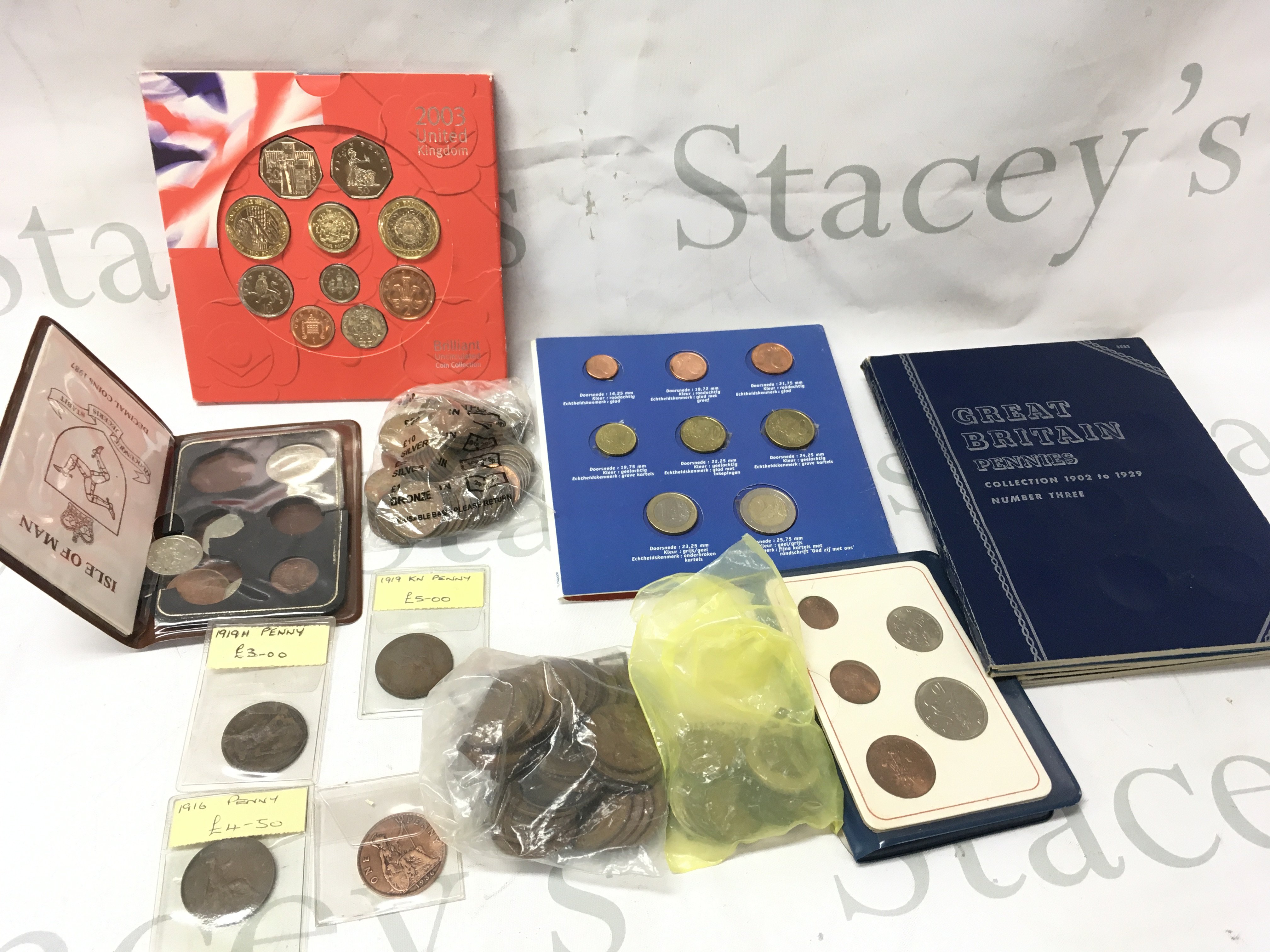 A small collection of British coinage including pennies KM and Heaton mint 1919 issue , 2003 British uncirculated coin collection etc . Postage category B