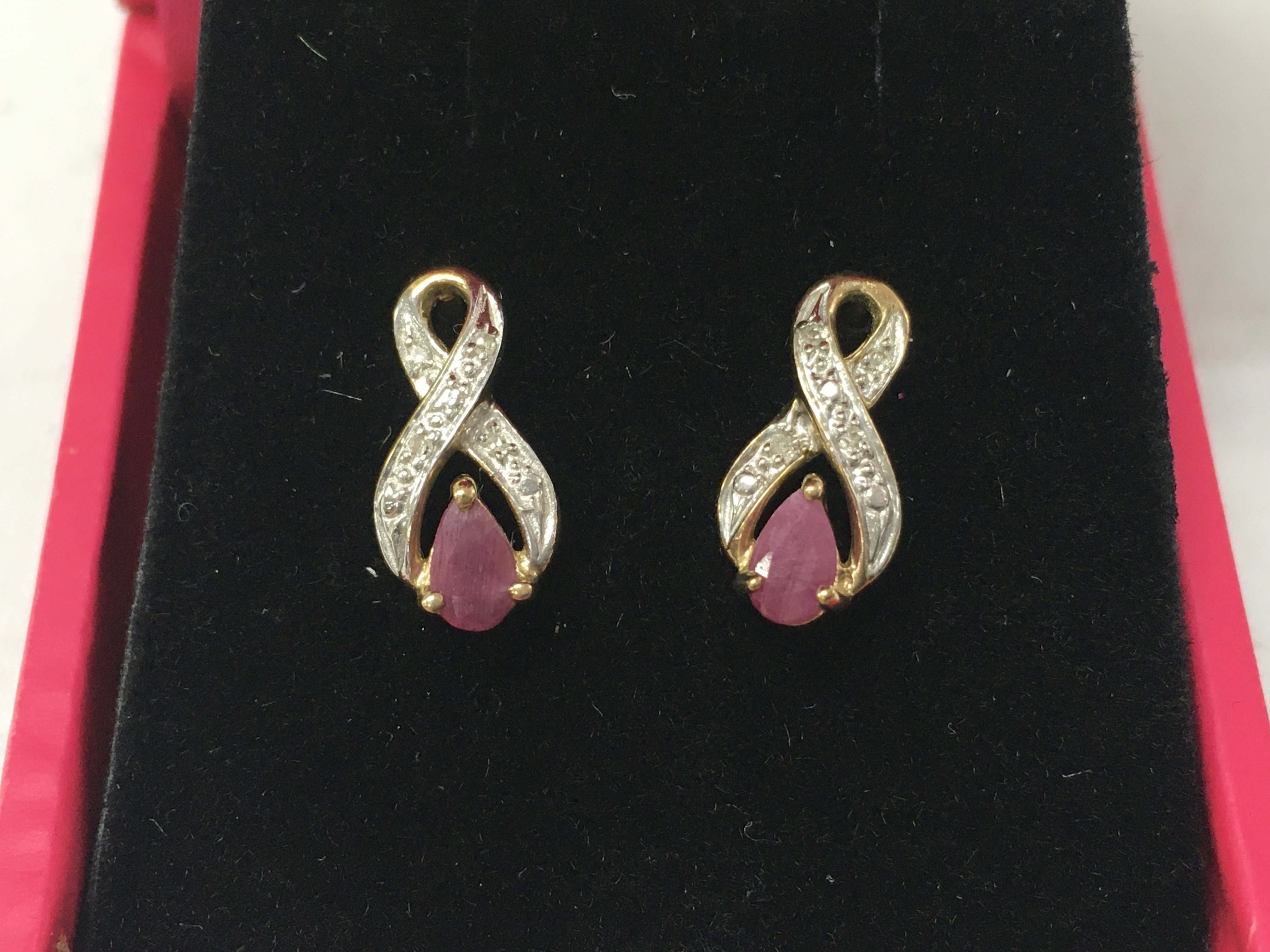 A pair of 9ct gold earring set with ruby and diamonds , 1.3G total weight. Postage category A