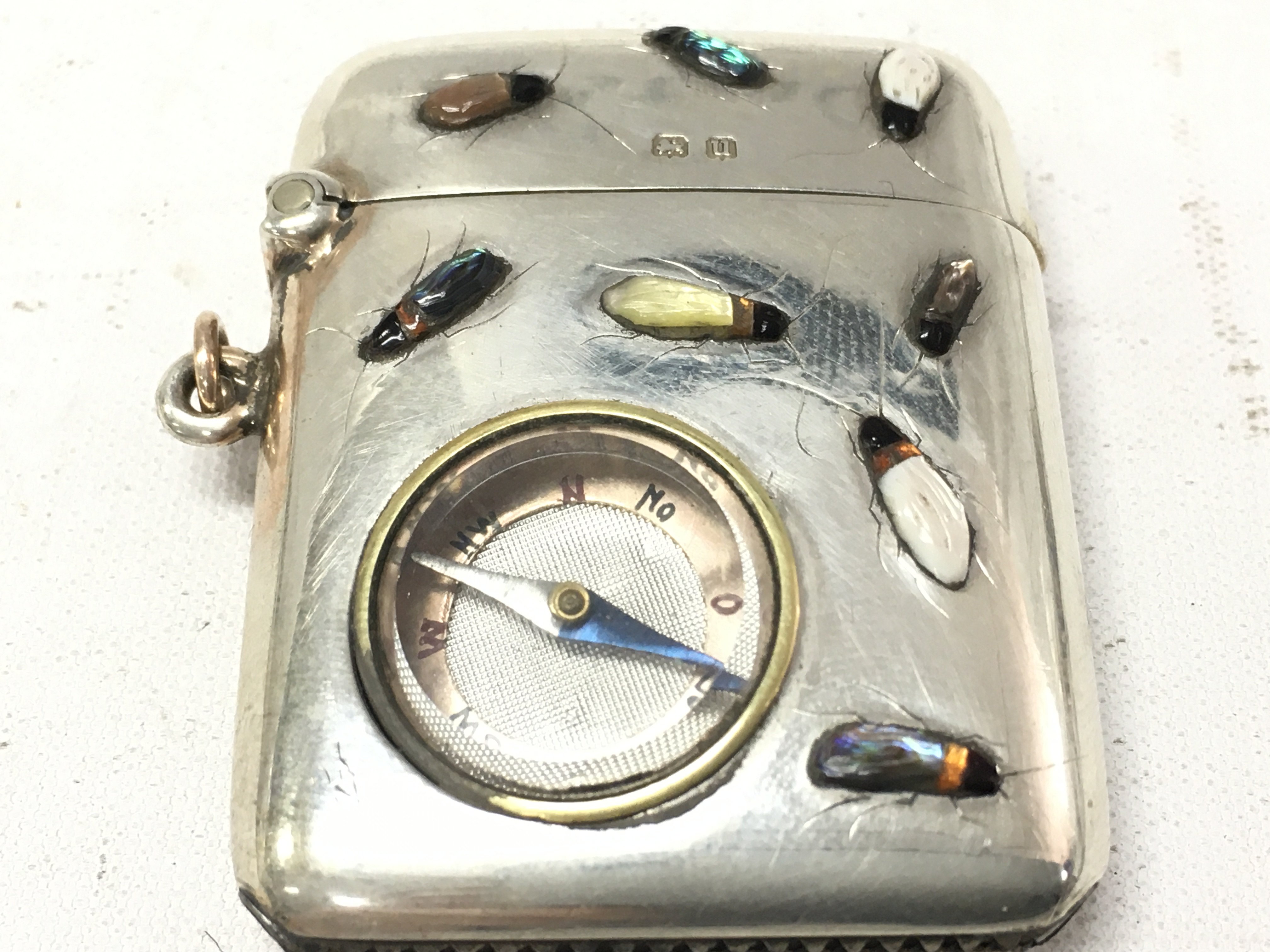 A silver vesta case set with shibyama bugs and compass. postage category A