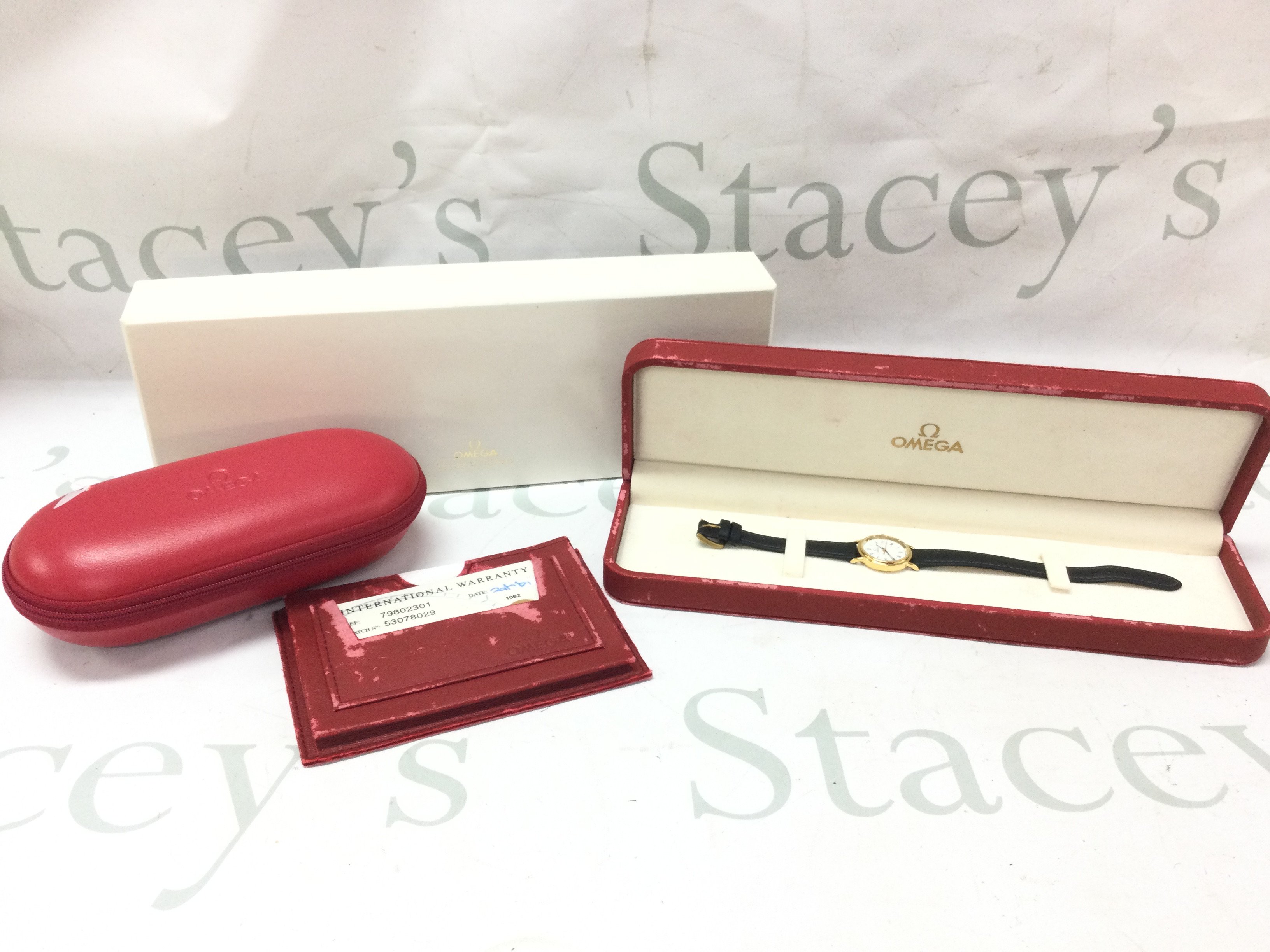 A ladies omega Deville wrist watch boxed (18ct cased) with papers and service box . Seen working.postage category b