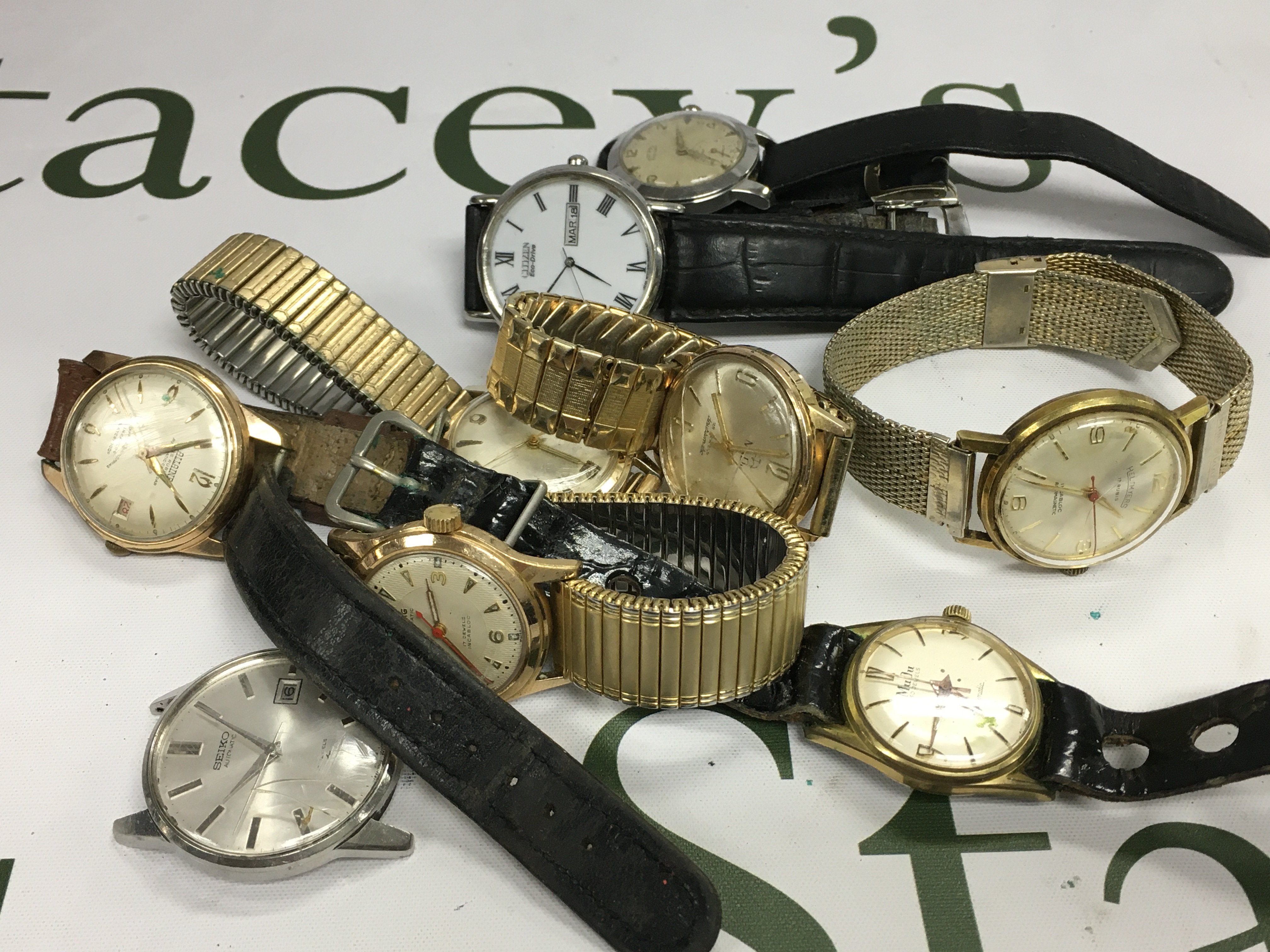 A collection of vintage watches including MuDu and Seiko examples.
