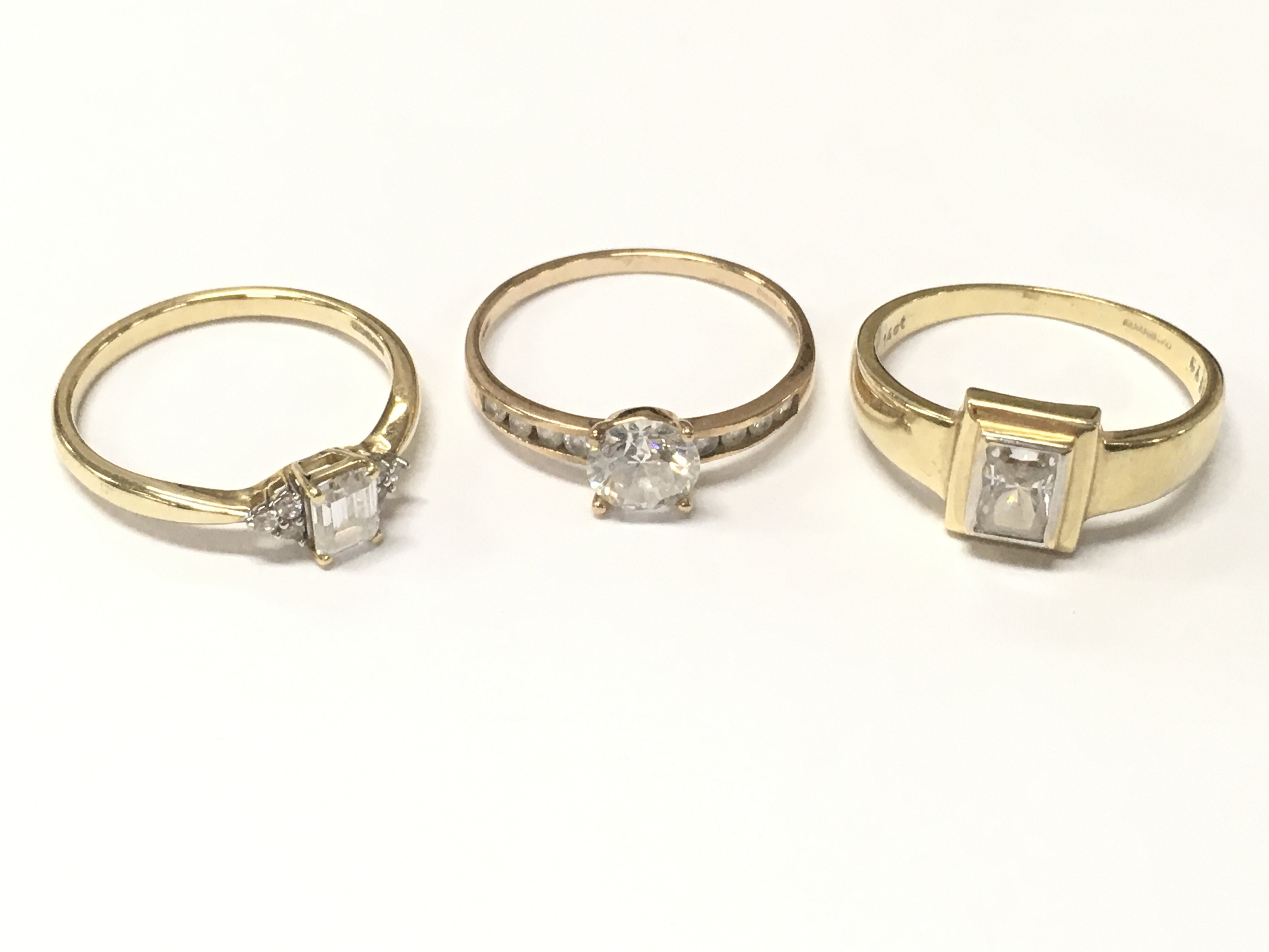 9 carat cubic zirconia set gold rings and one 14ct ring , 7g total weight. Sizes O,P and Q. Postage category A