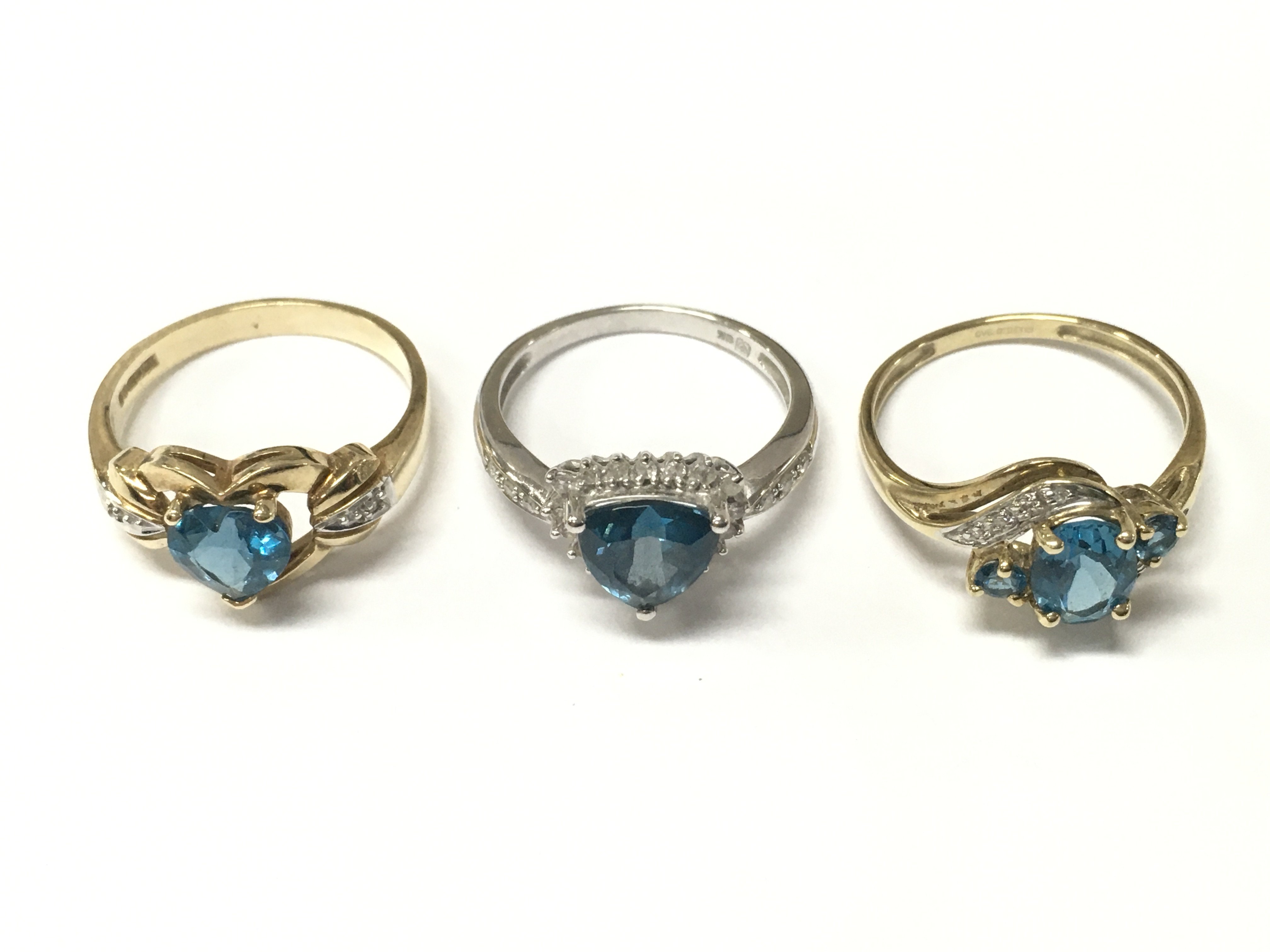 9 carat gold blue topaz set rings . 8.6g total weight. Sizes P & Q. Postage cat a