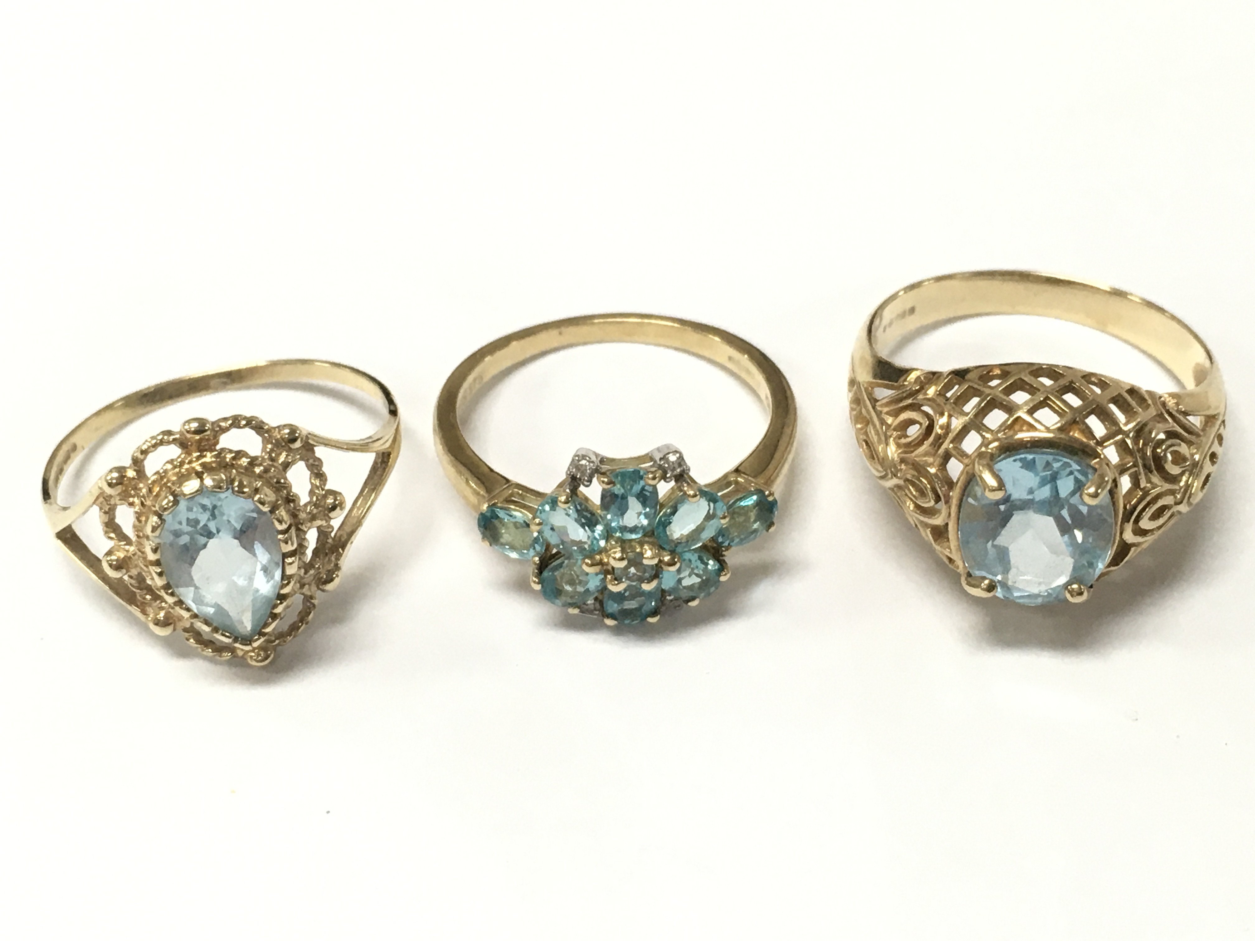 9 carat gold blue topaz rings . 8.4g total weight. Sizes P, O and Q. Postage category A