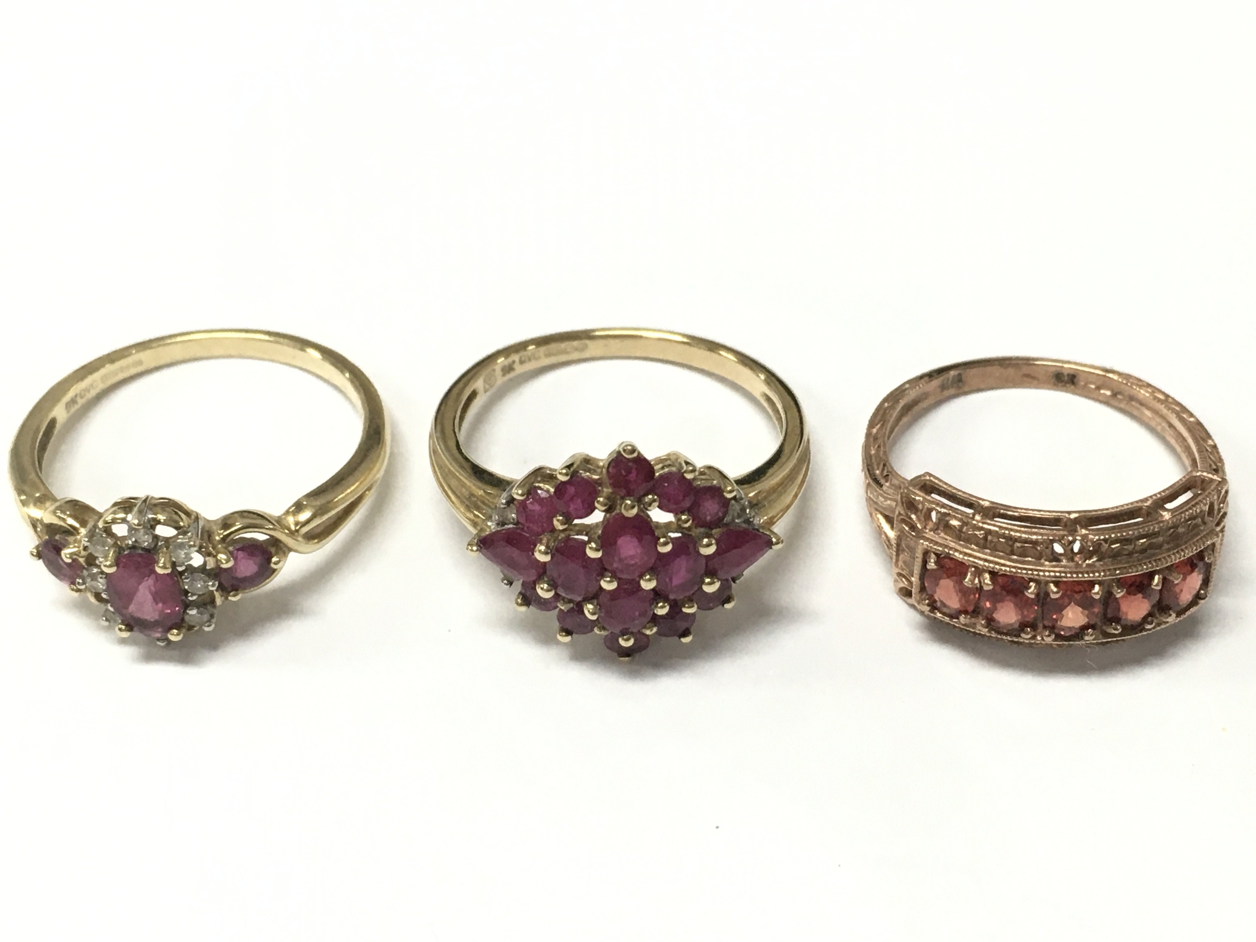Two 9ct and one 8ct gold rings including a ruby cluster, garnet half band etc . Size Q and O. Total weight 8.8g Postage category A