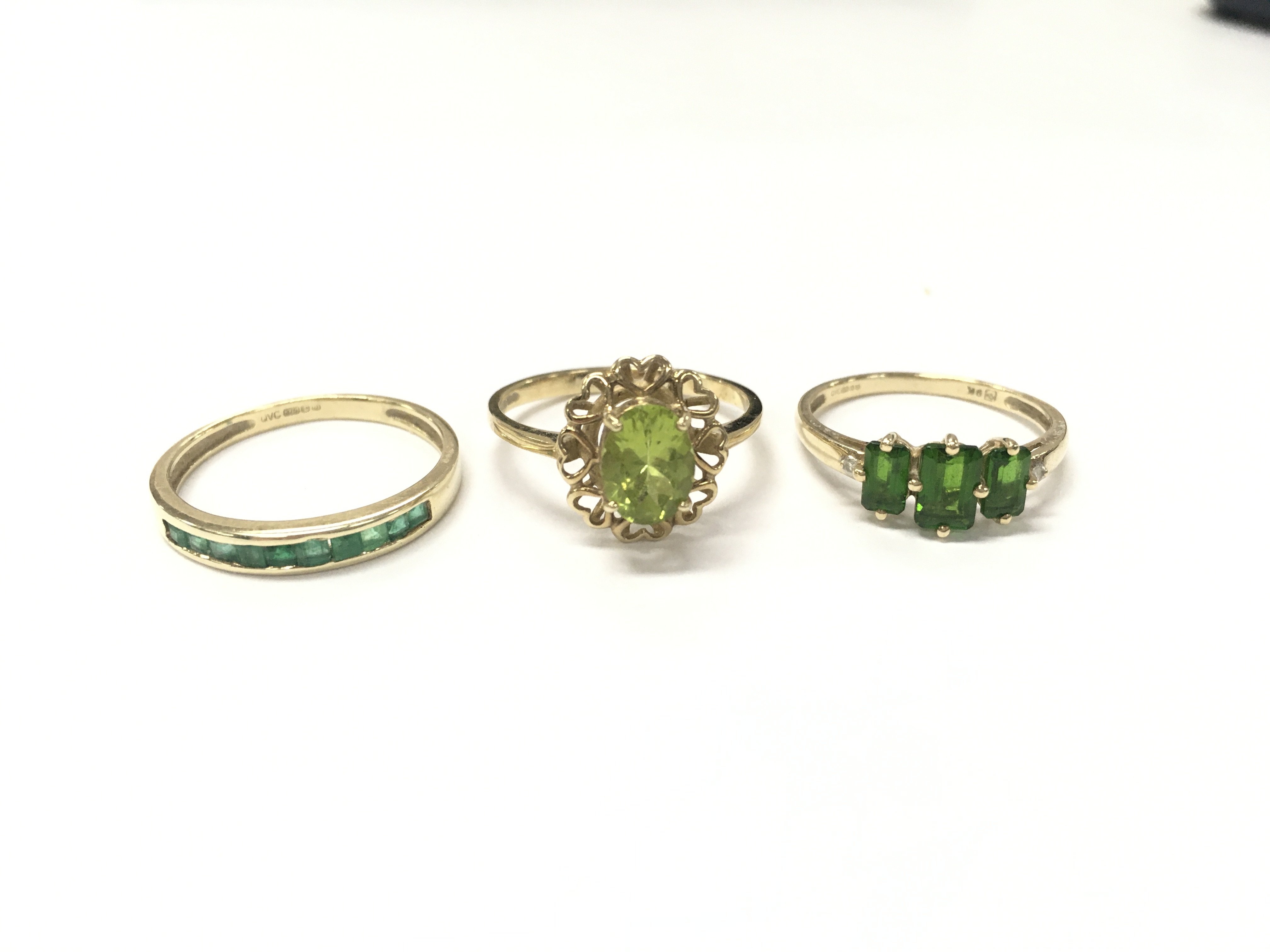 9 carat gold rings including an emerald half band , peridot ring, Diopside ring. 5.8g total weight. Sizes Q and O. Postage catA