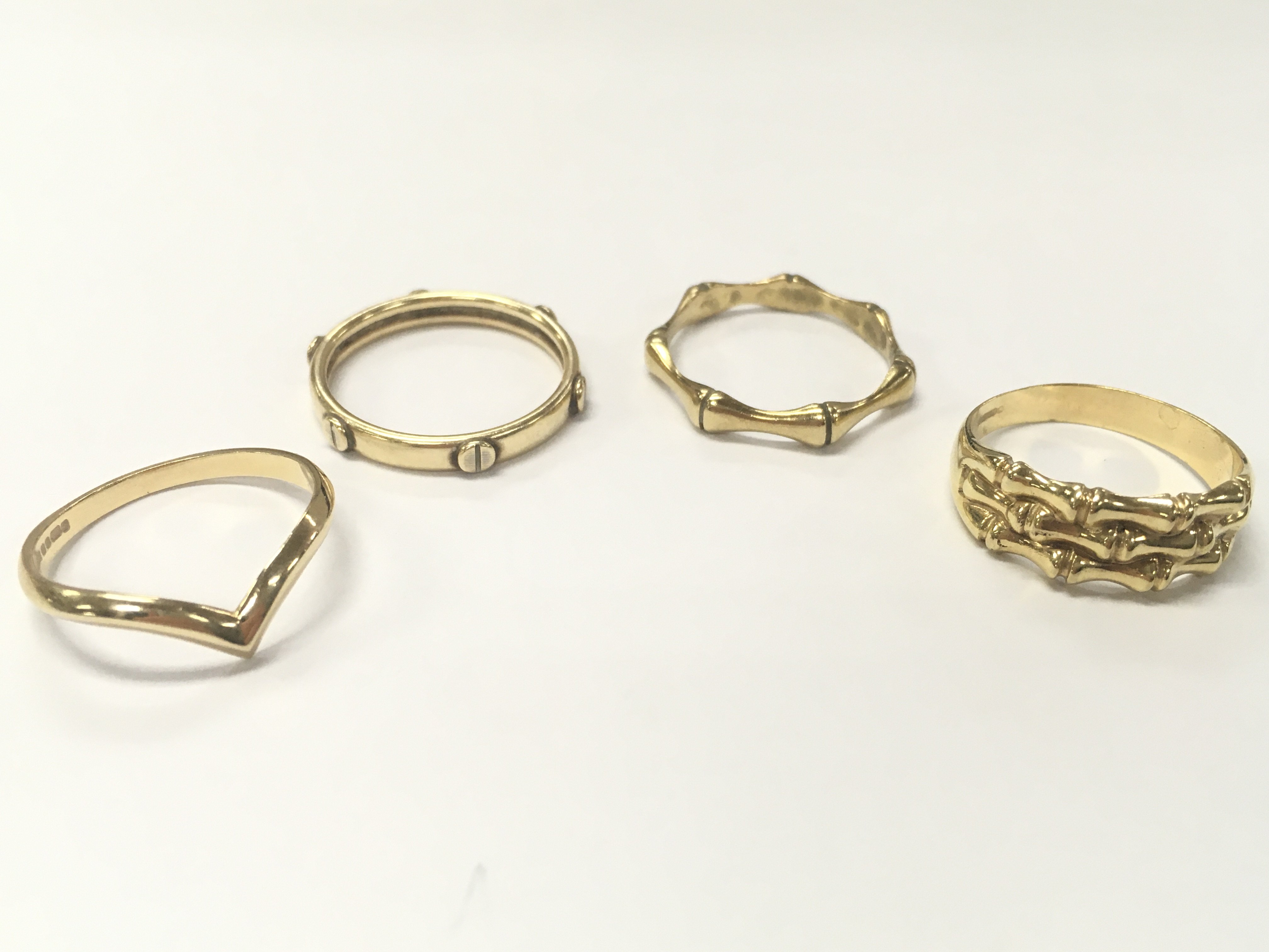 Three 9 carat gold rings and one 14ct gold ring . 9.8g total weight. Sizes S/R, Q. Postage category A