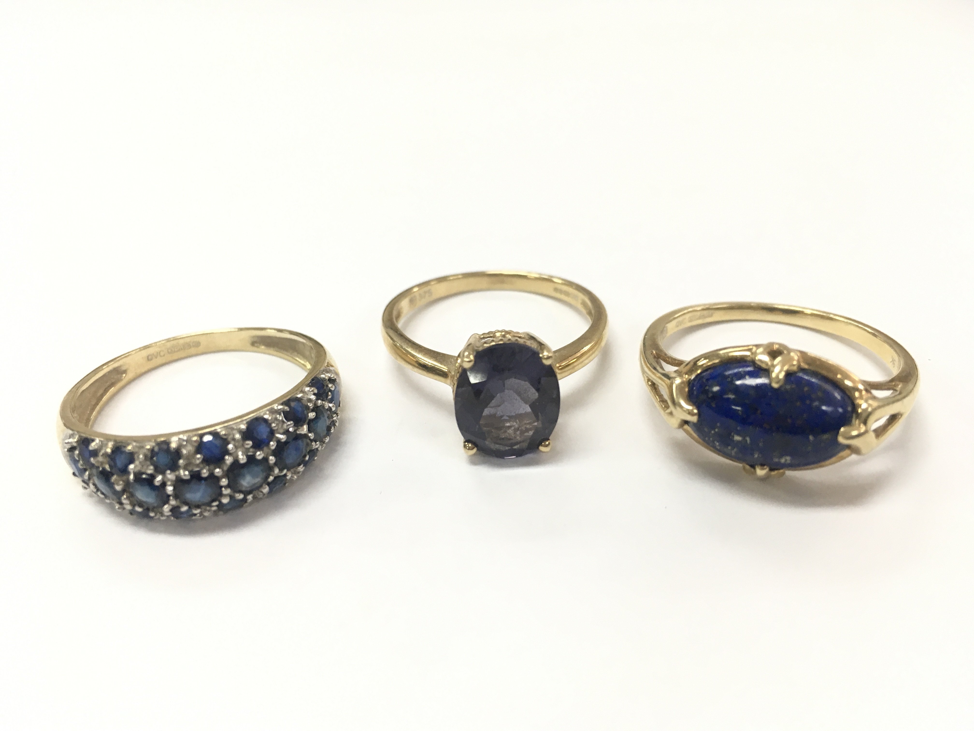 9ct gold rings including a blue sapphire half band ring size Q 2.6g , purple stone cocktail ring size O 2.5g , lapis ring 2.9g size Q. Postage category A