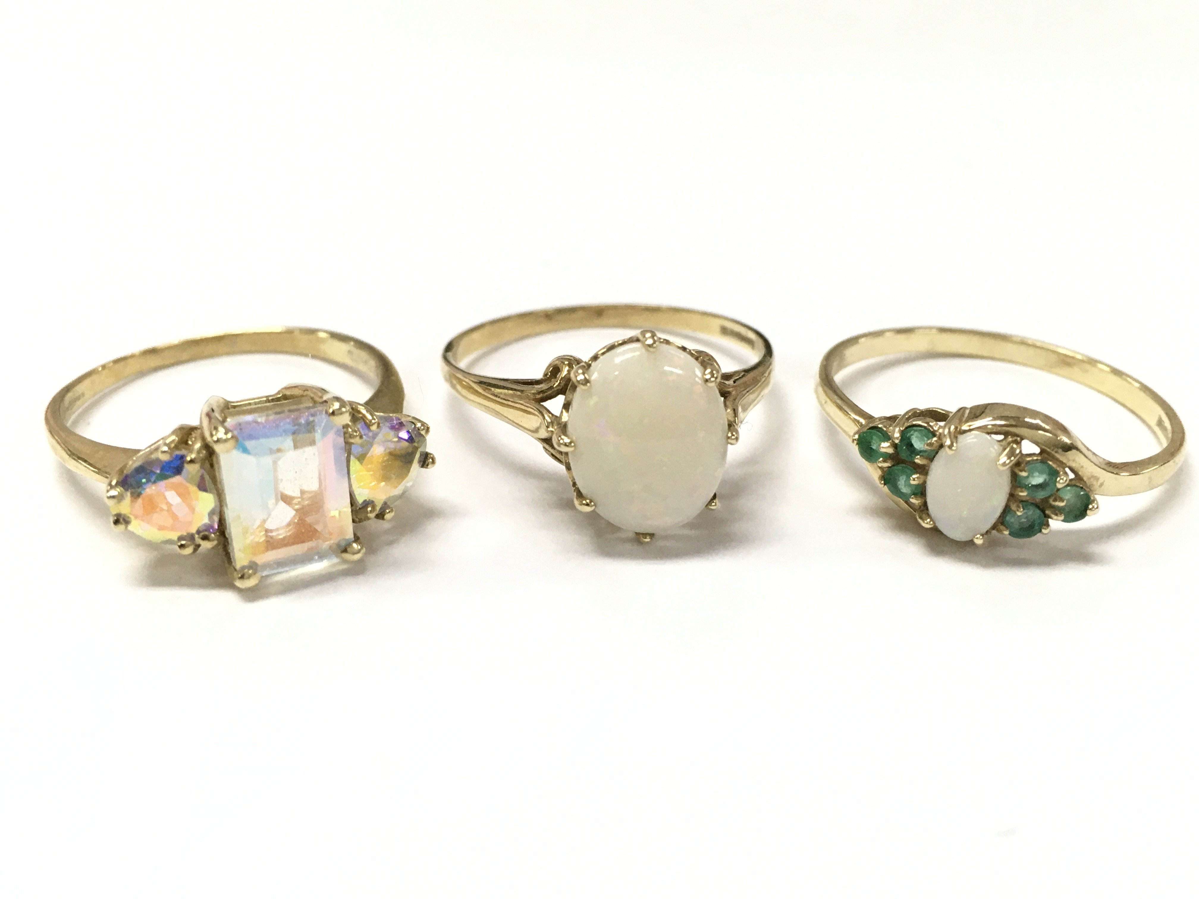 9ct gold rings , including a mystic set stone ring (size N), Opal stone set ring (size Q), Opal and green stone (size R) .6.1g total weight. Postage category A