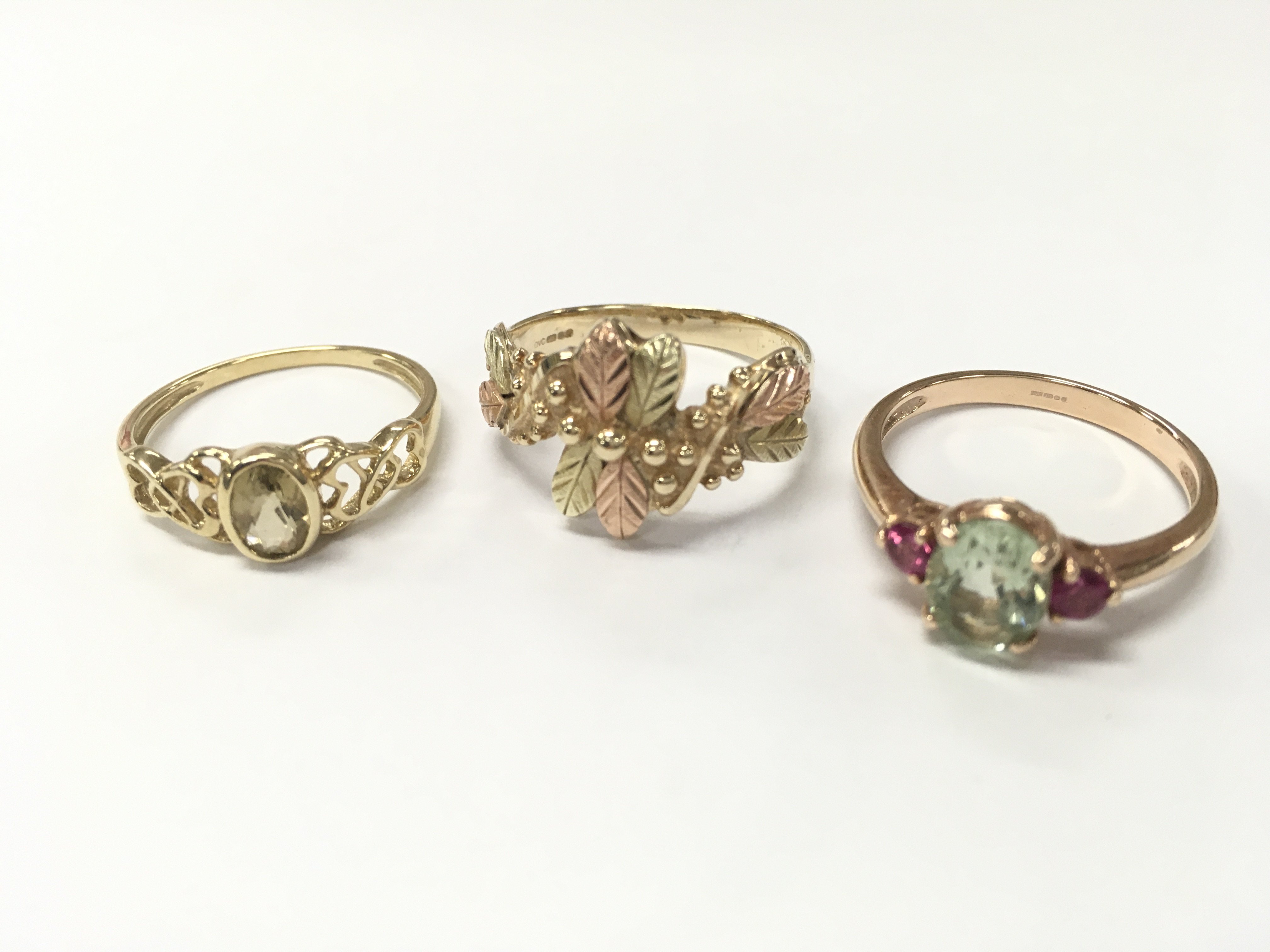 Three 9ct gold rings including a Celtic style ring (size O), Black Hills style ring (size R) , Tourmaline and pink amethyst set ring (ring size P). 7.8g total weight, Postage category A
