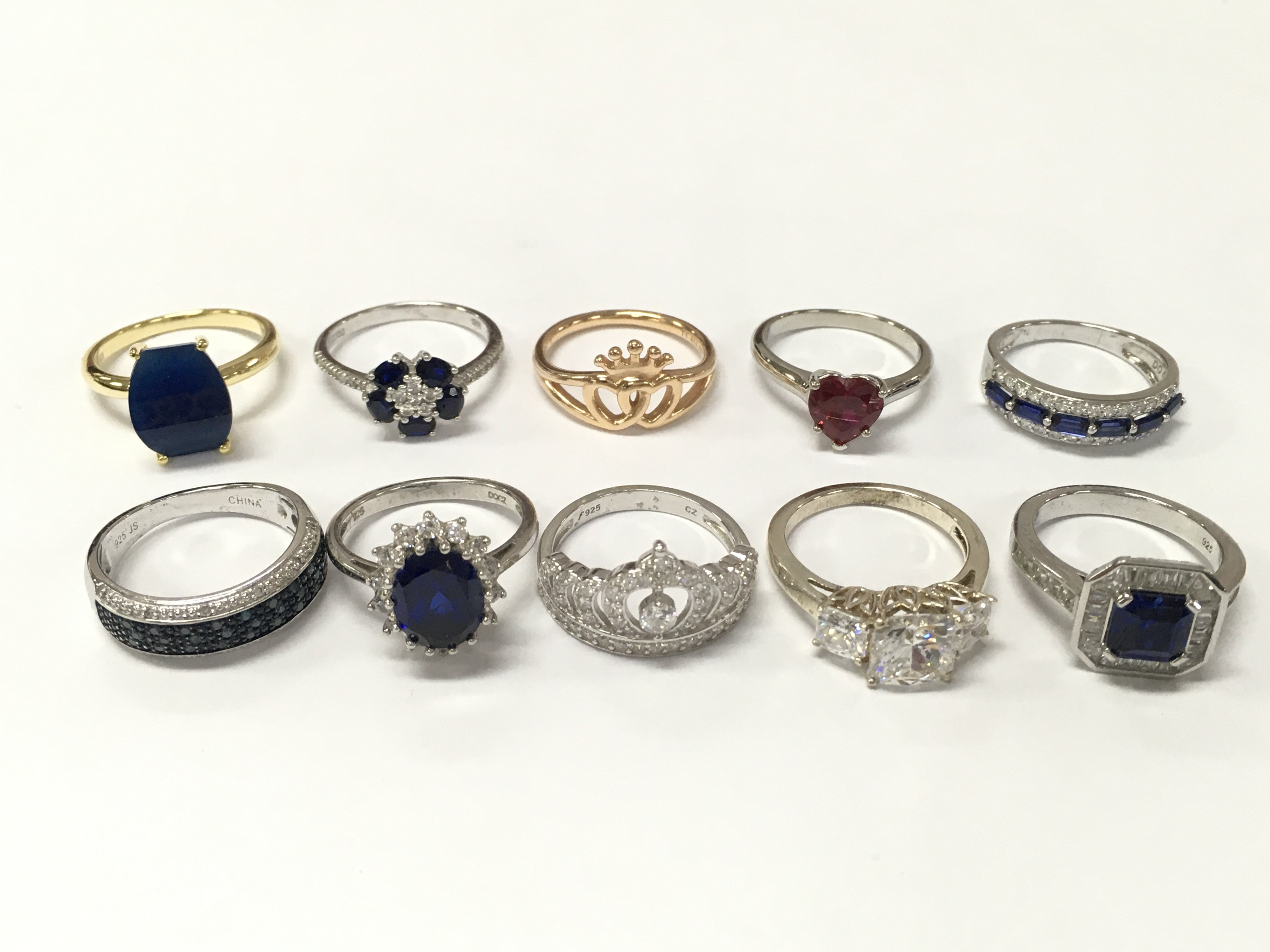 A Collection of silver rings including blue sapphire, CZ set rings etc. 35g total weight Approx . Sizes mostly P & O. Postage category A
