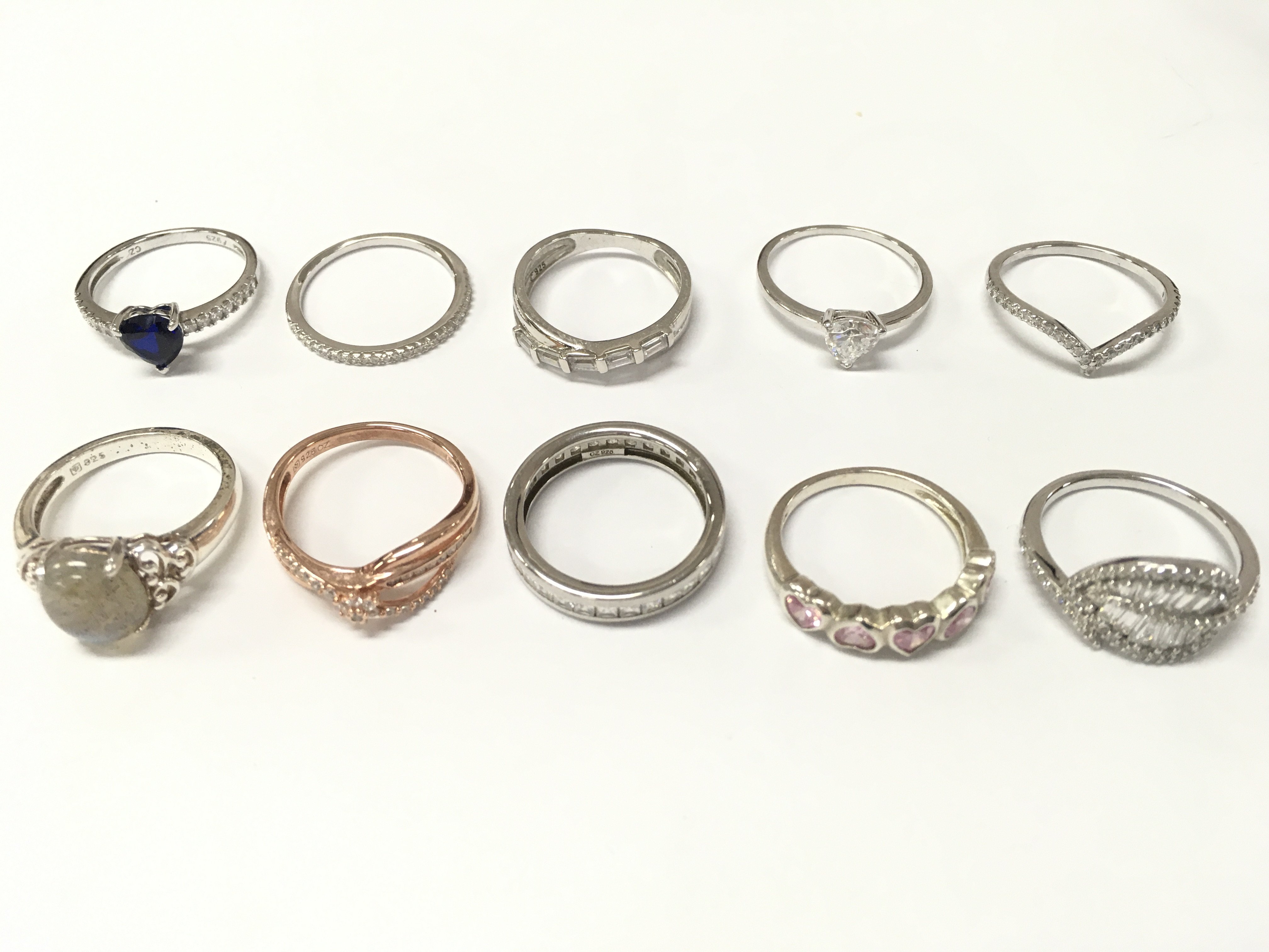 Silver rings , some set with CZ stones. Mostly sizes O,P. 24g total weight approximately . Postage category A
