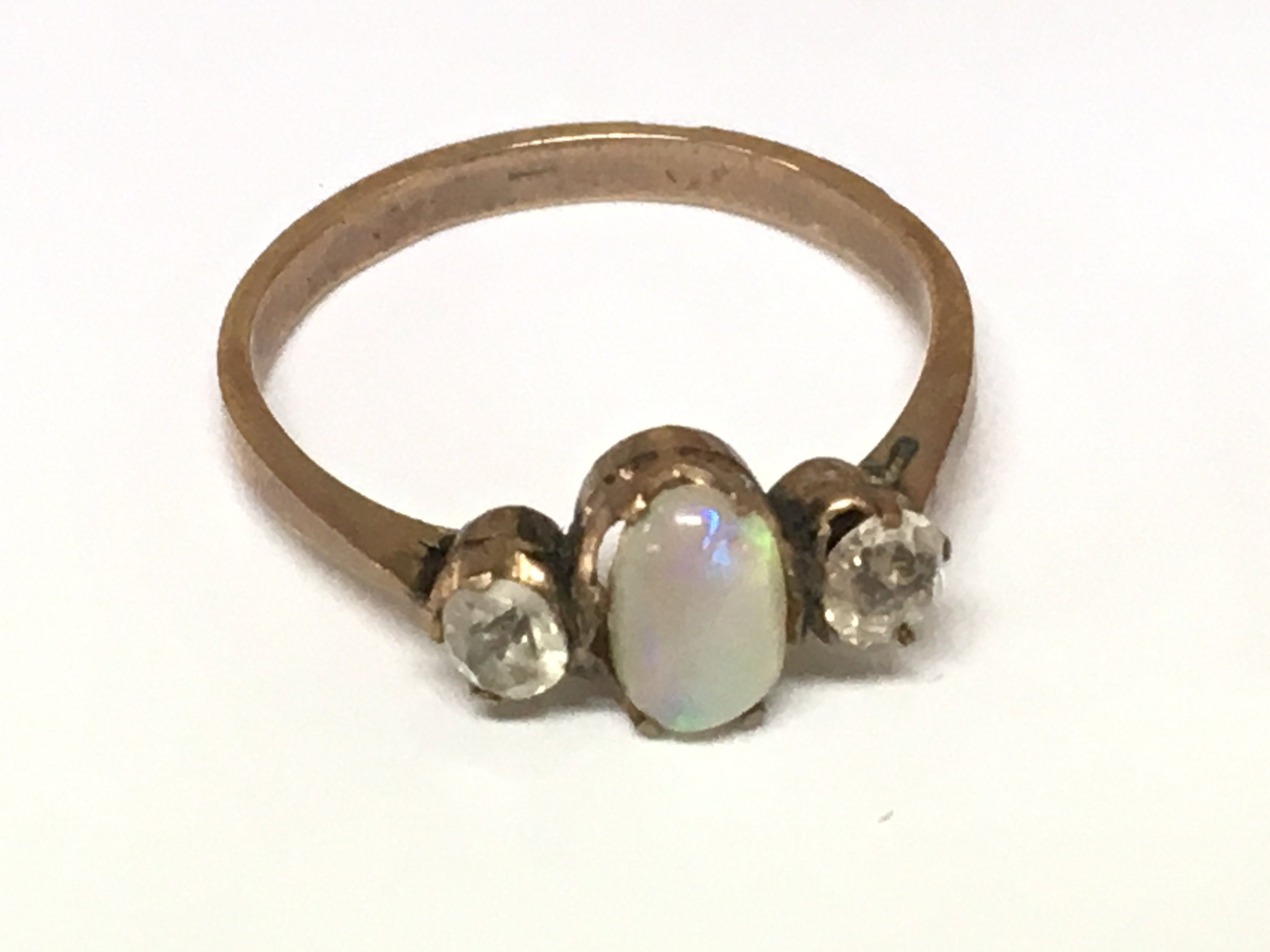 A yellow metal opal ring and white stones. Size M 1.73g