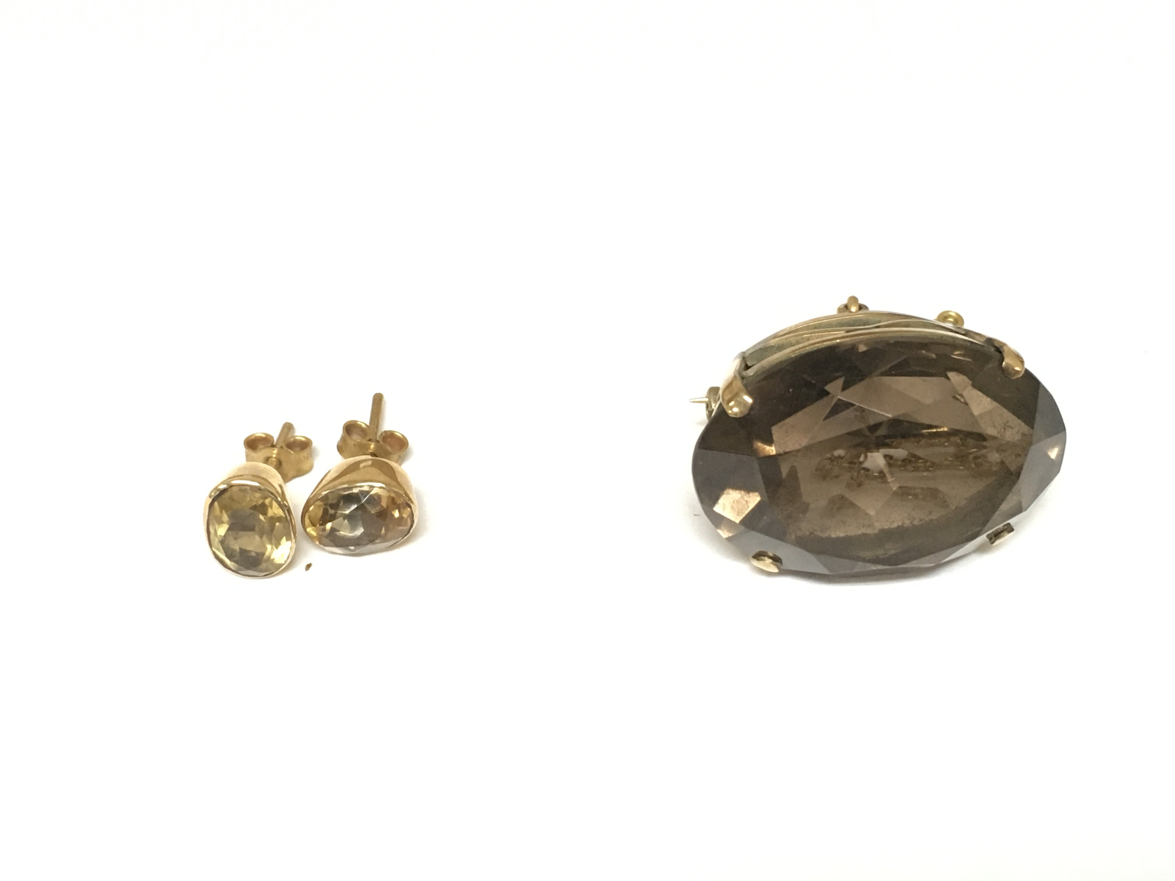 A pair of citrine earrings and a large quartz brooch.