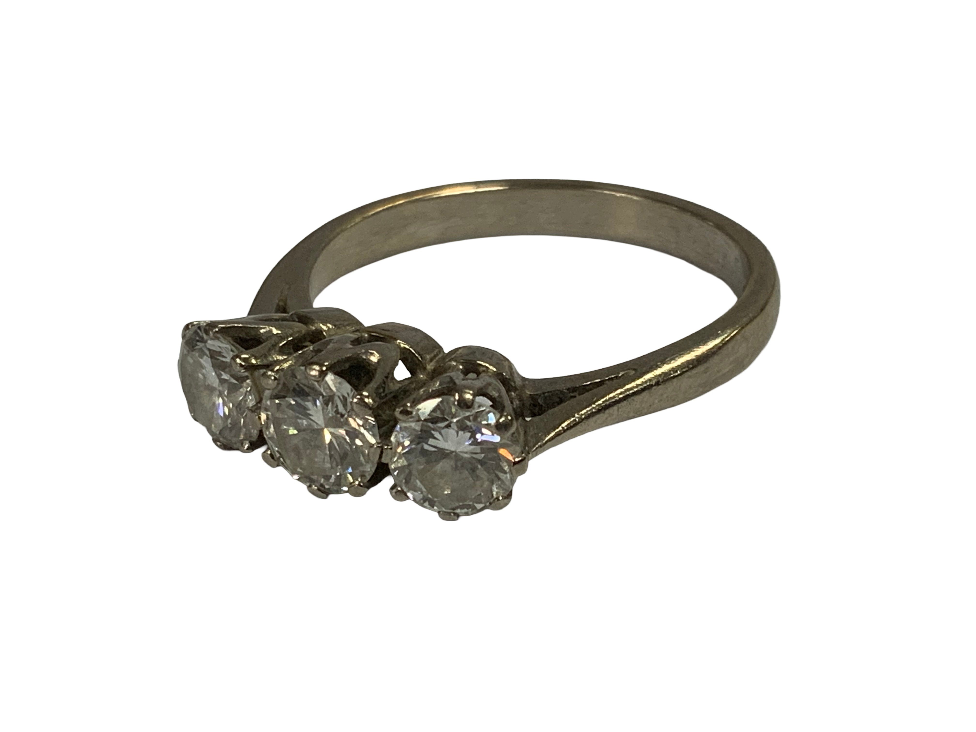 An 18ct white gold 3 stone diamond trilogy ring, Size O.